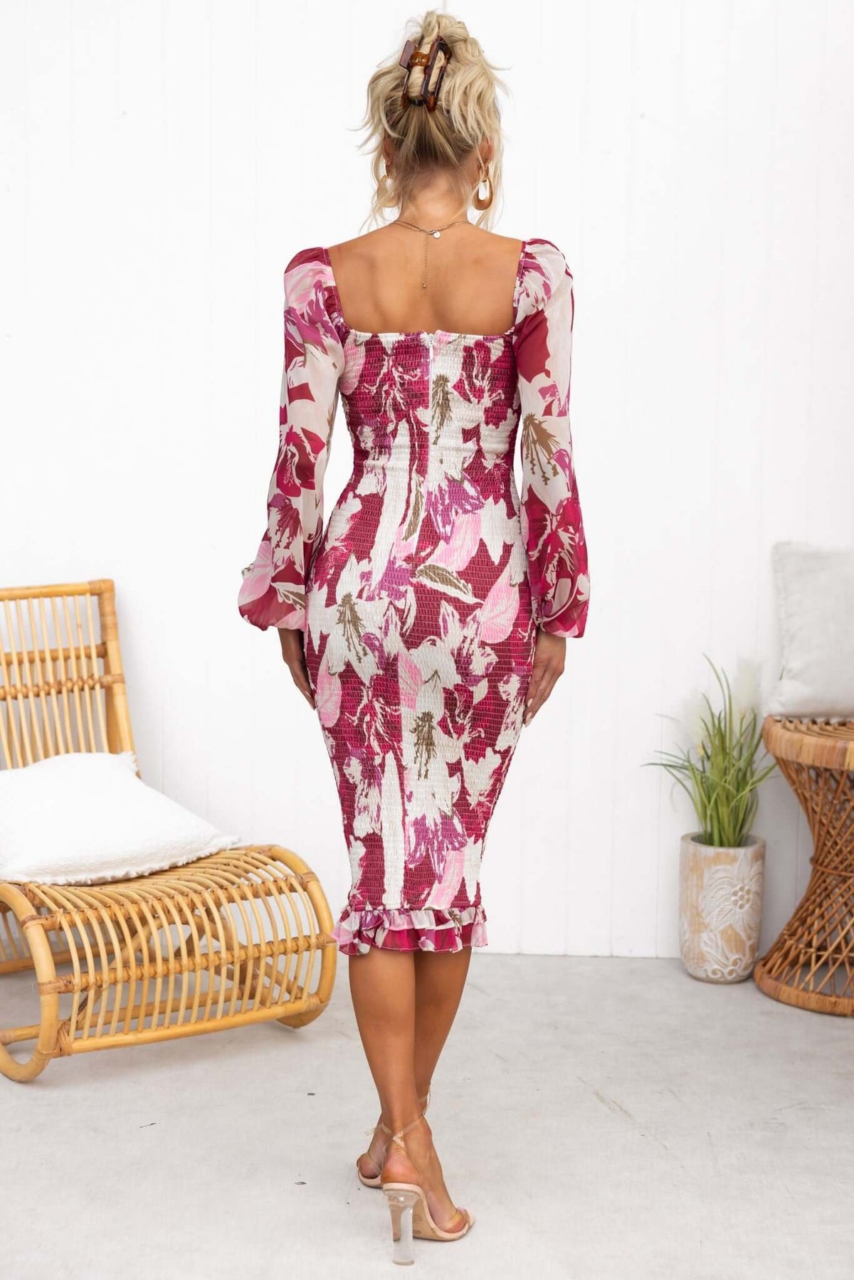 Back view of Naples Midi Dress in floral print, showcasing elastic sleeves and fitted design on a model.