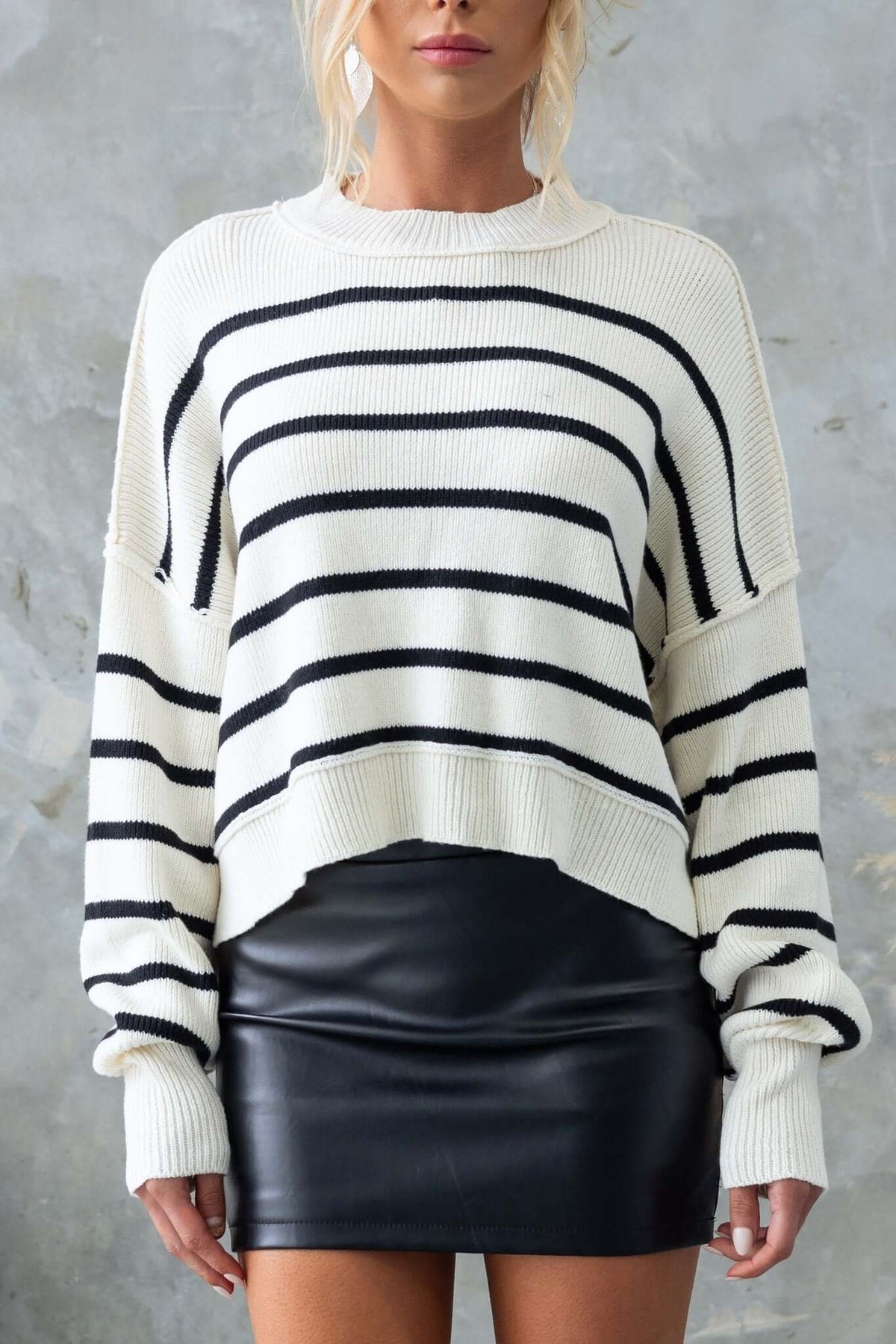 Pekin Jumper with mock neckline and side splits, featuring black and white stripes, styled with a black leather skirt.