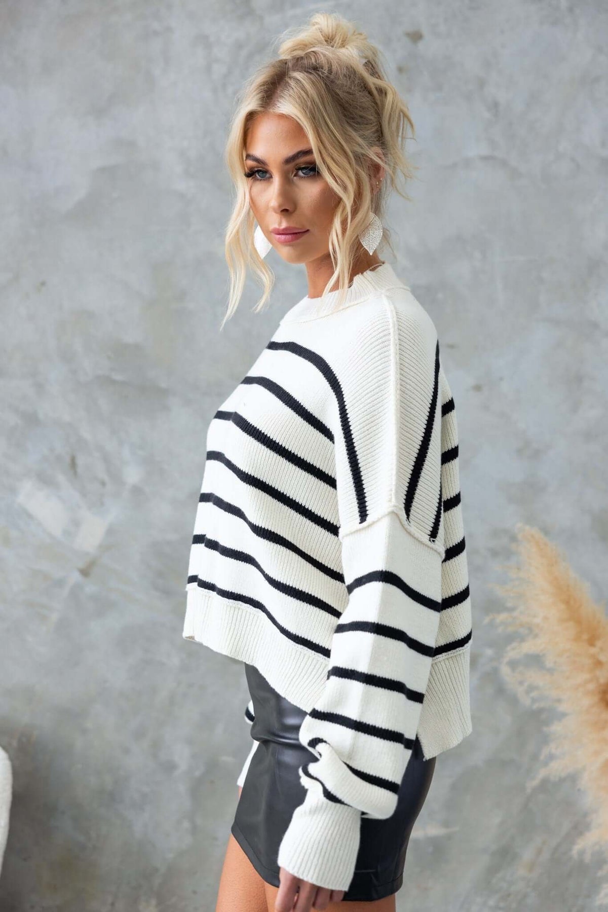 Pekin Jumper with mock neckline and side splits, featuring a striped design and relaxed fit, model wearing size 8/S.