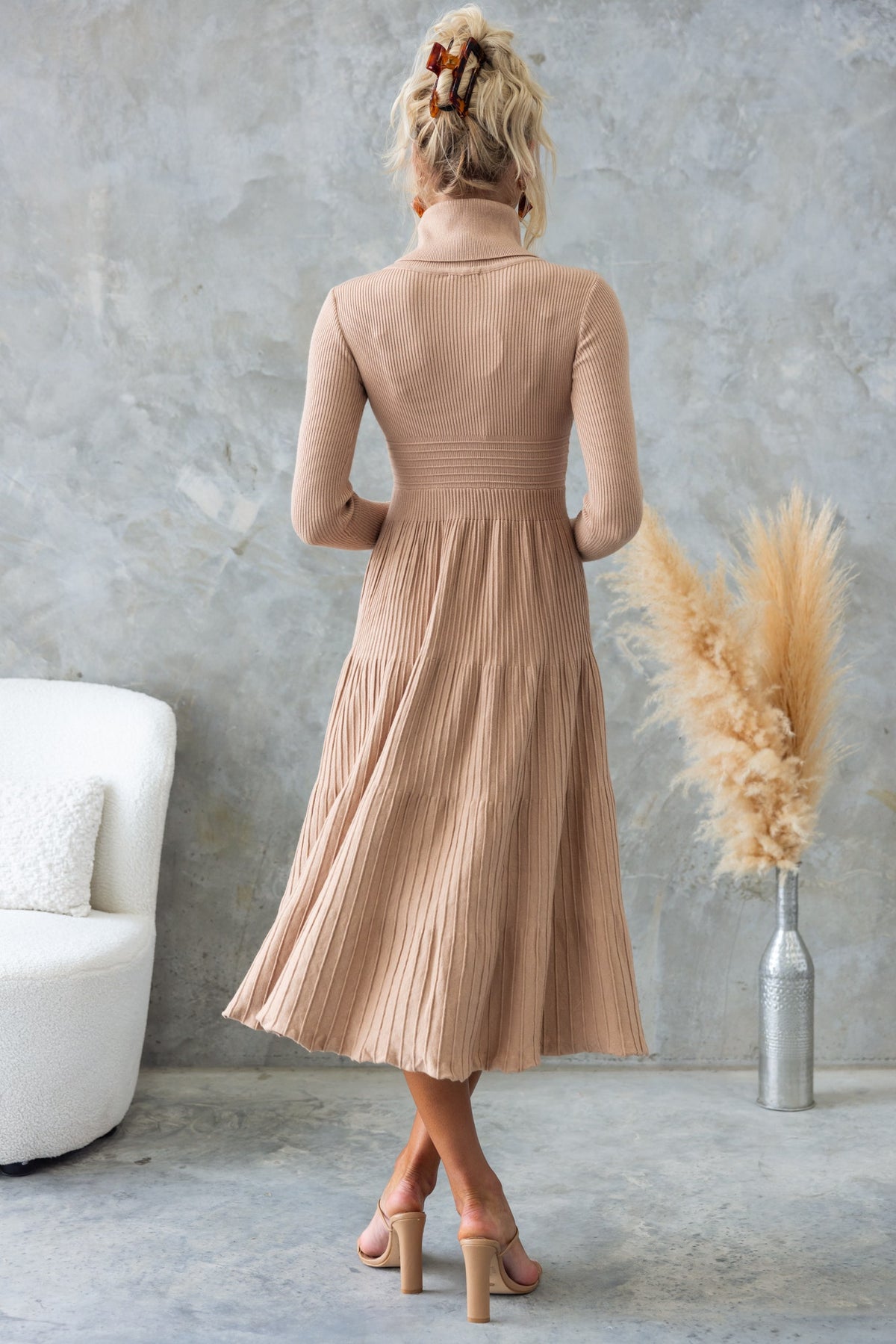 Back view of Parkley Midi Dress in beige with turtle neckline and pleated skirt, styled for a modern look.