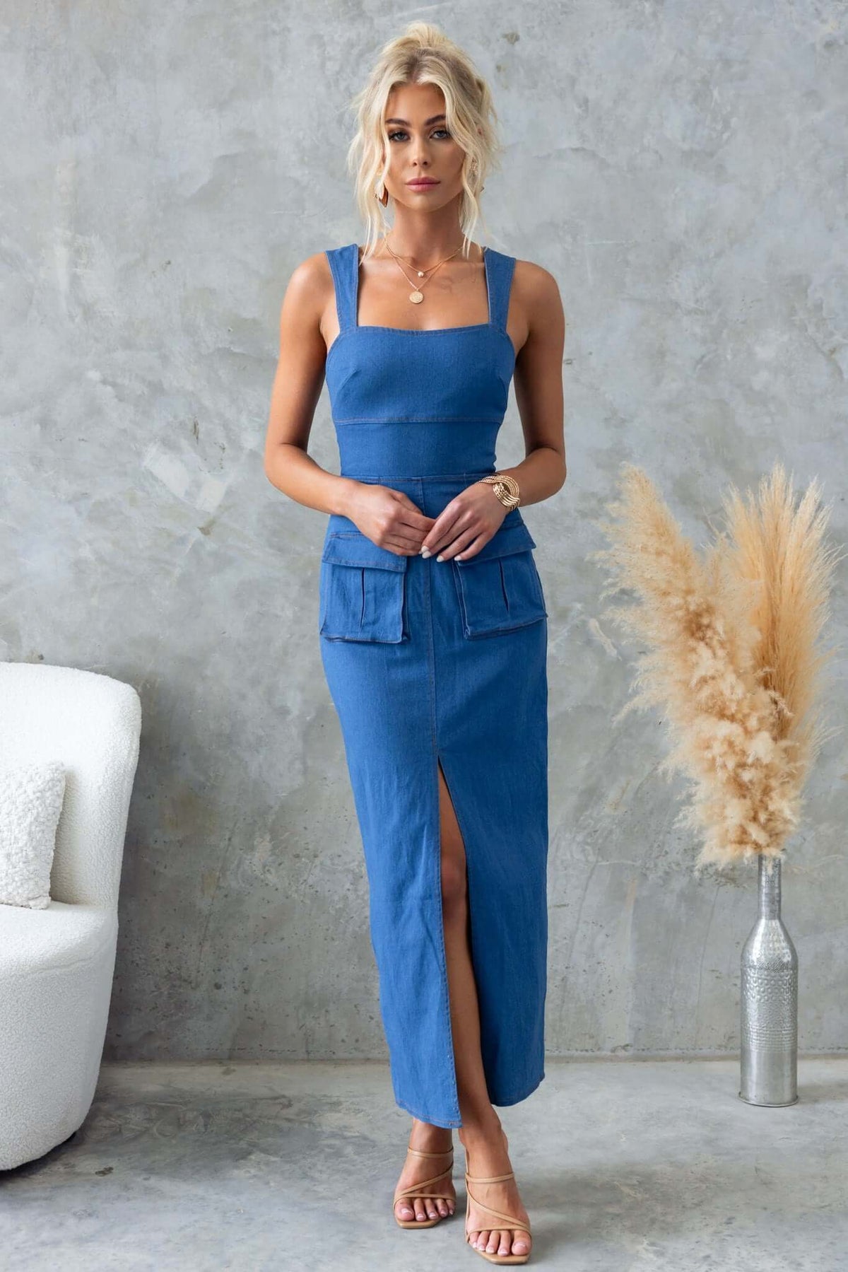 Model wearing Jovan Denim Midi Dress with adjustable straps, front split, and pockets in stylish setting.