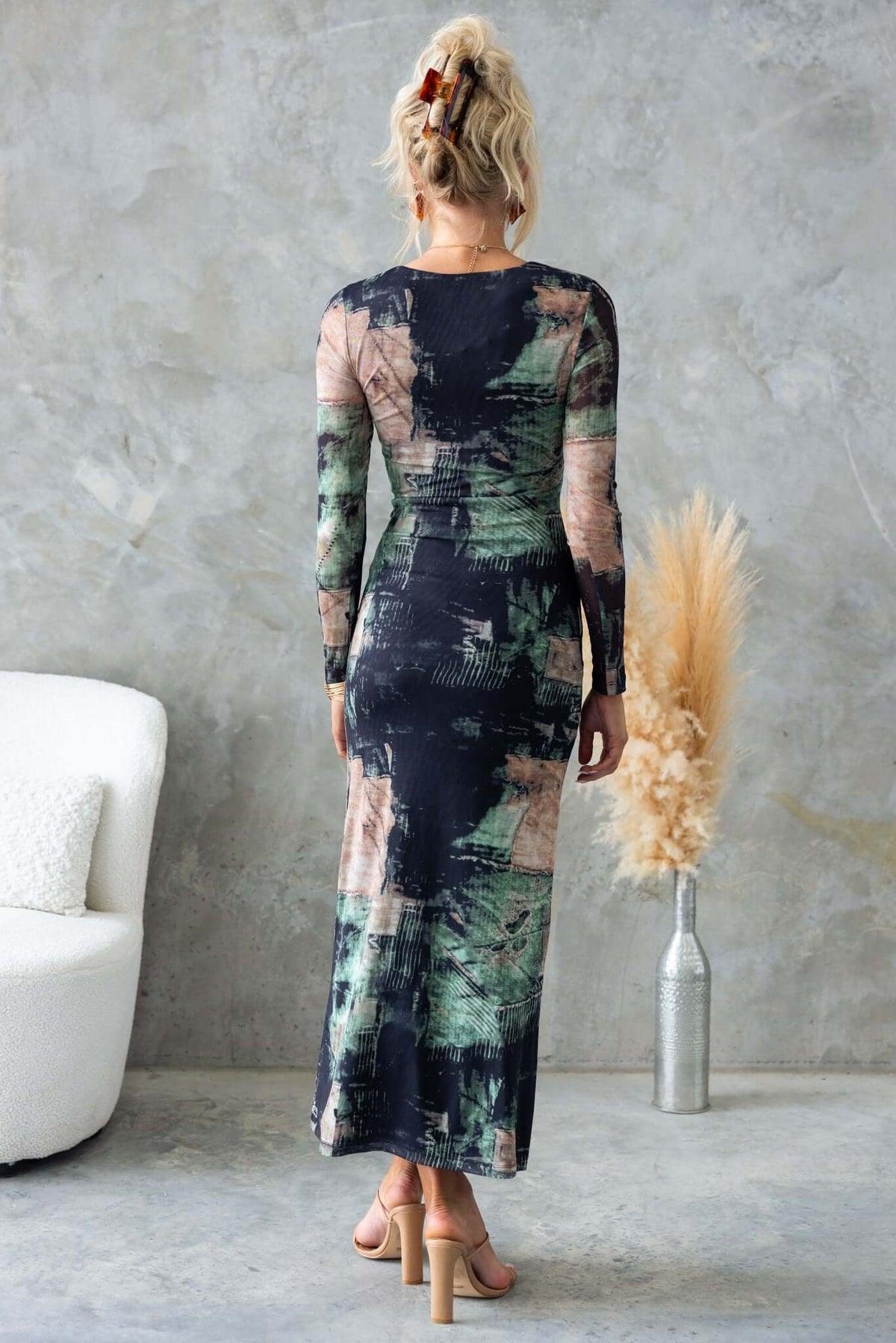 Back view of Mystique Maxi Dress featuring black and green abstract patterns, long sleeves, and a figure-hugging fit.