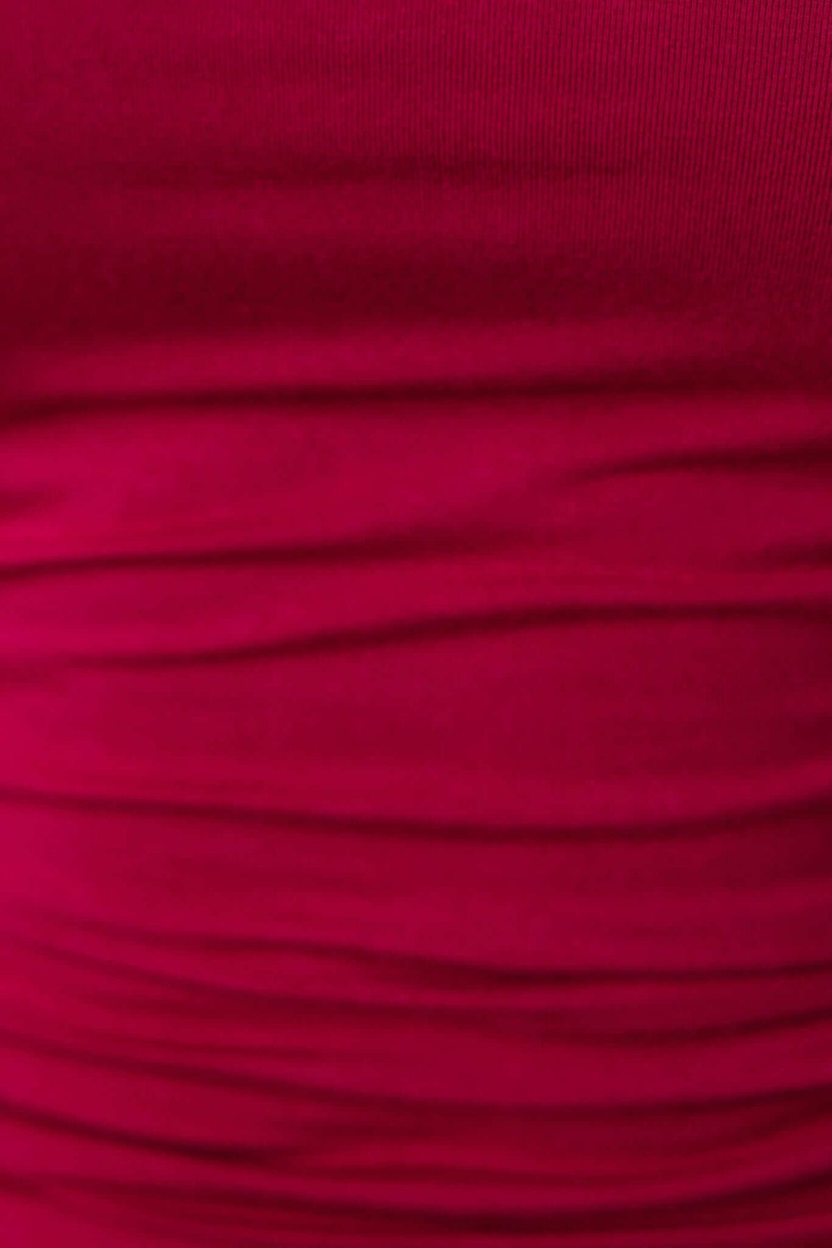 Close-up of soft, stretchy pink fabric with a textured, ruched finish, ideal for bodycon dresses like the Anneke Dress.