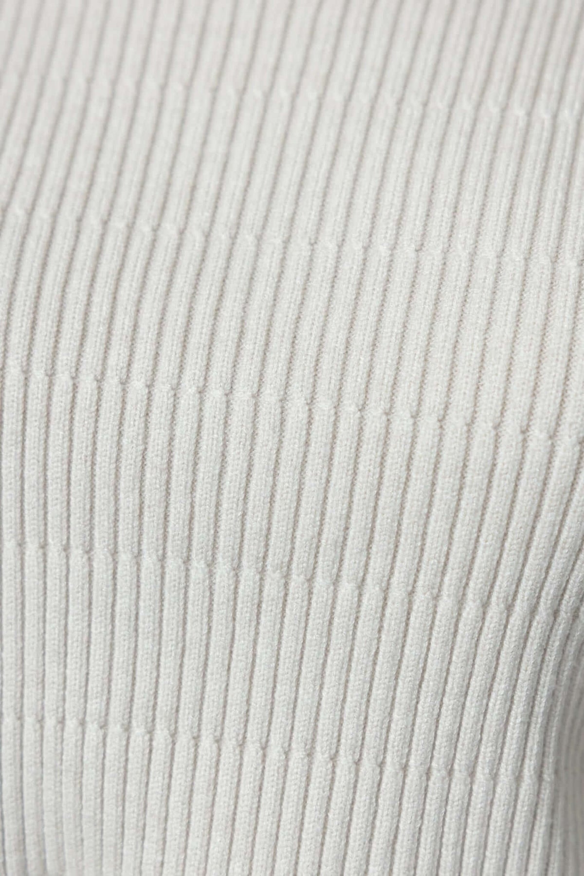 Close-up of ribbed knit material in light color, showcasing texture for Wheaton Dress.