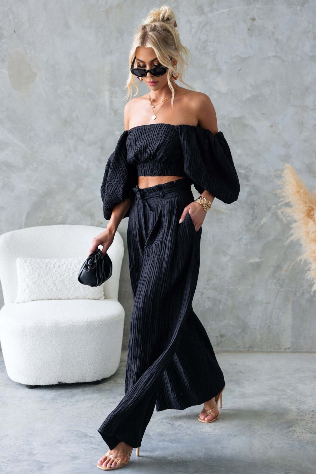 Model wearing Know Better Pants in black, featuring mid-high waist, textured material, and removable tie.