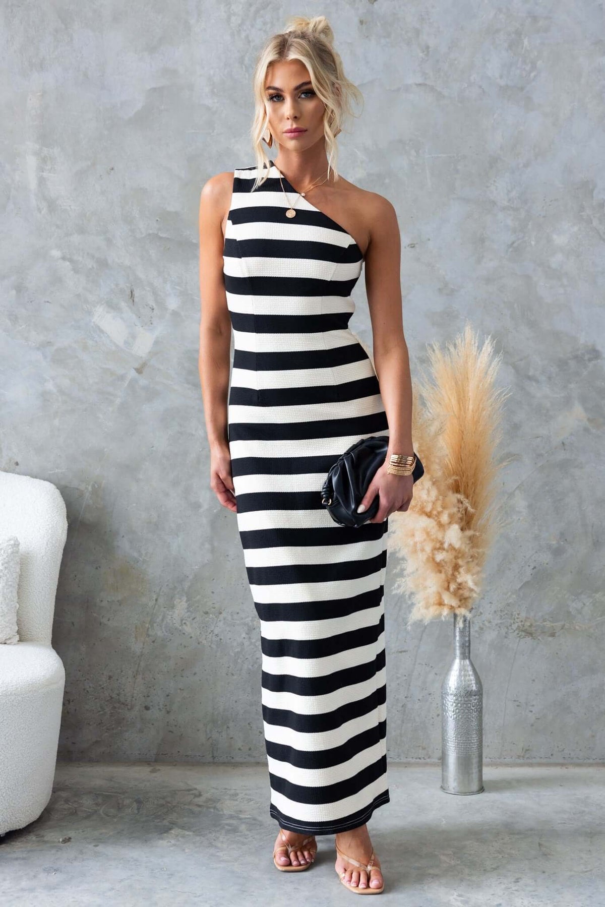 Caserta Maxi Dress featuring a one-shoulder neckline and textured striped design in black and white.