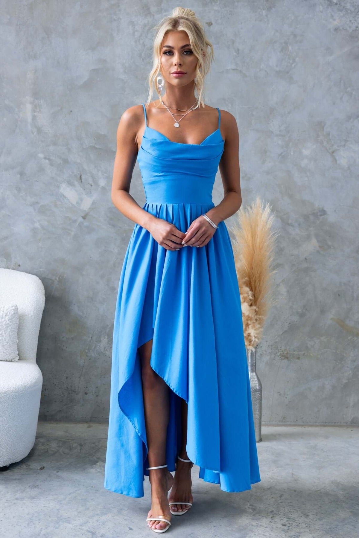 Adalita Maxi Dress in bright blue, featuring adjustable straps, padded bust, and asymmetrical hemline, styled elegantly.