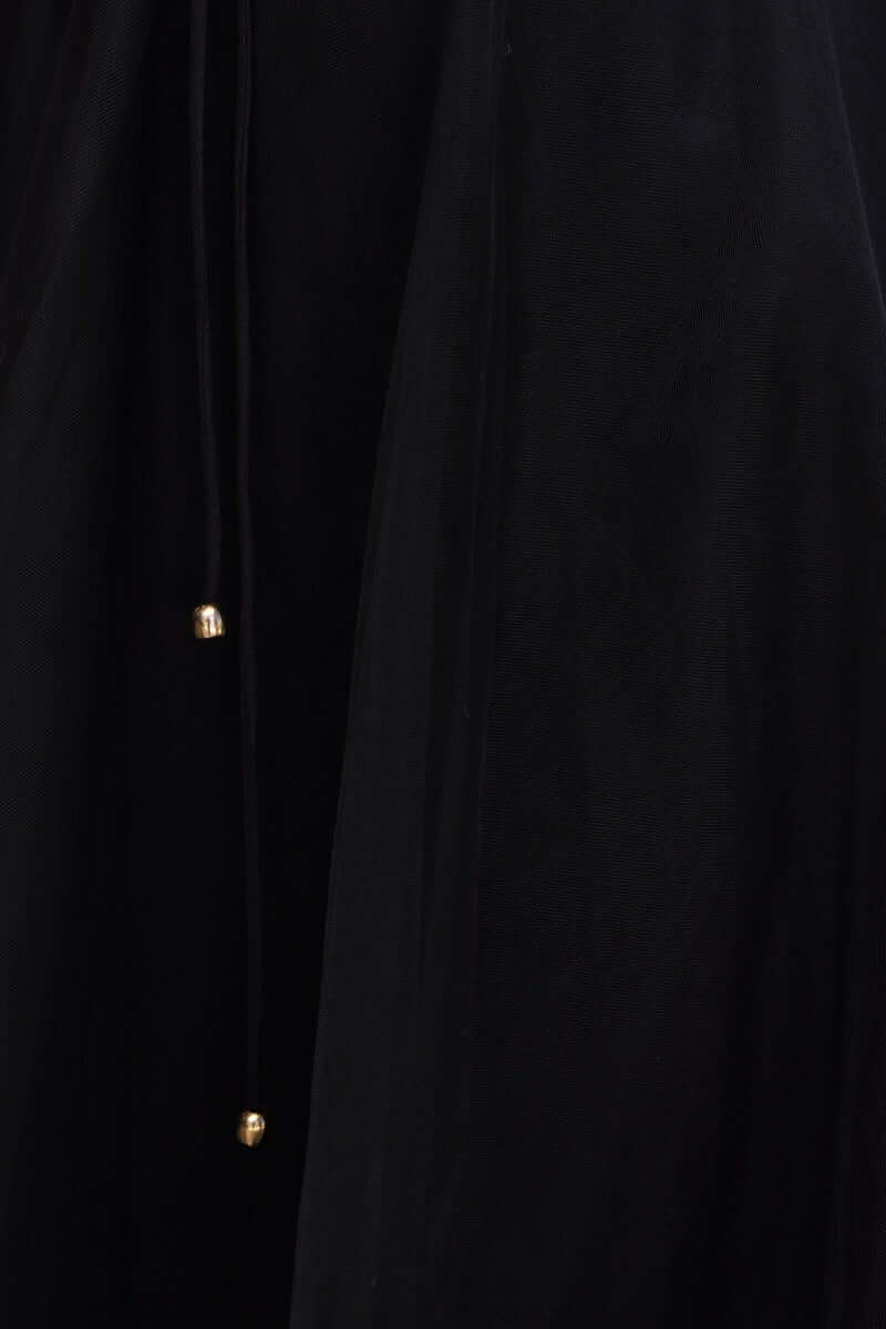 Close-up of the black tulle Wash Away Maxi Dress, highlighting the adjustable tie and gold detailing.