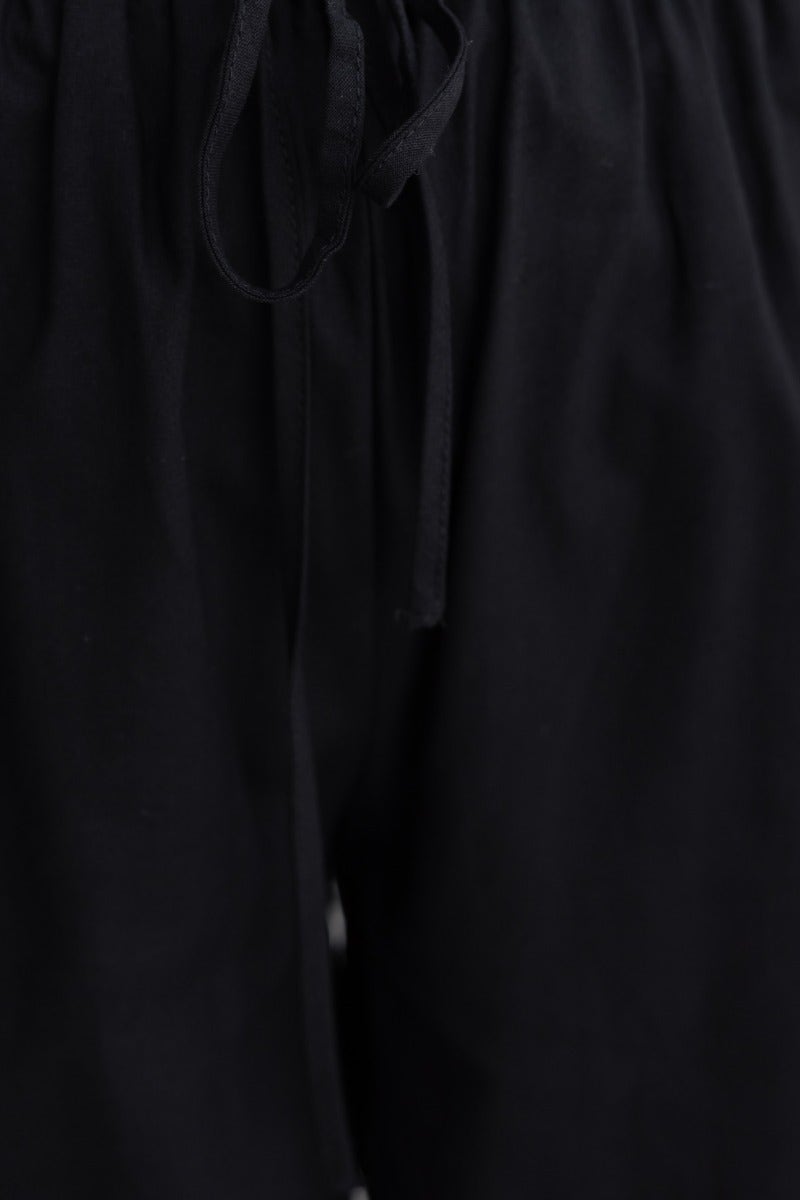 Black cotton Peru Pants featuring an elastic waistband with drawstring for added comfort and stylish wide legs.