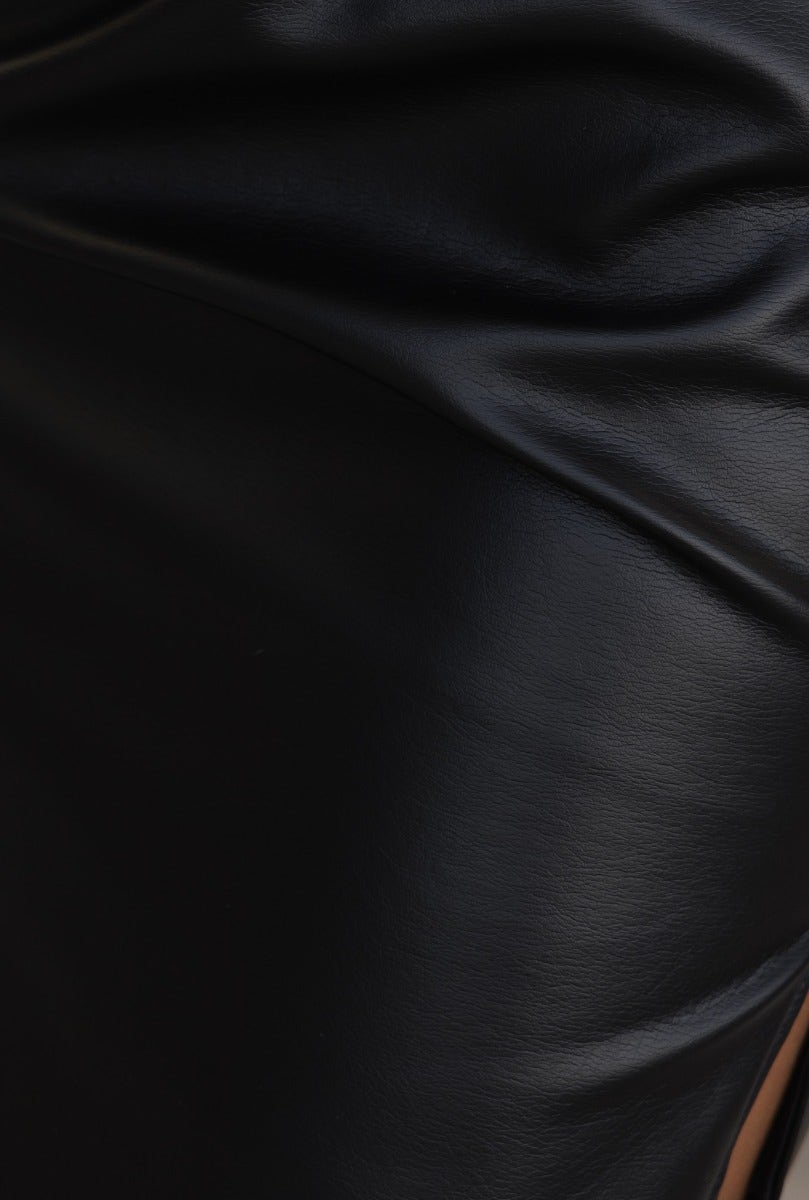 Close-up of black faux leather fabric with elegant sheen from the Pannie Midi Dress, showcasing its smooth texture.
