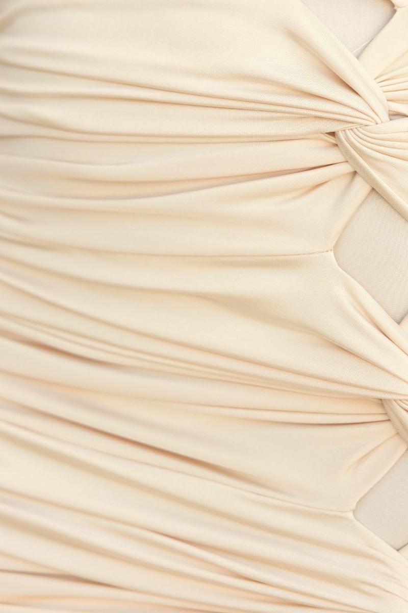 Close-up of Xandy Dress fabric showing ruching details and twist accents in a soft beige color.
