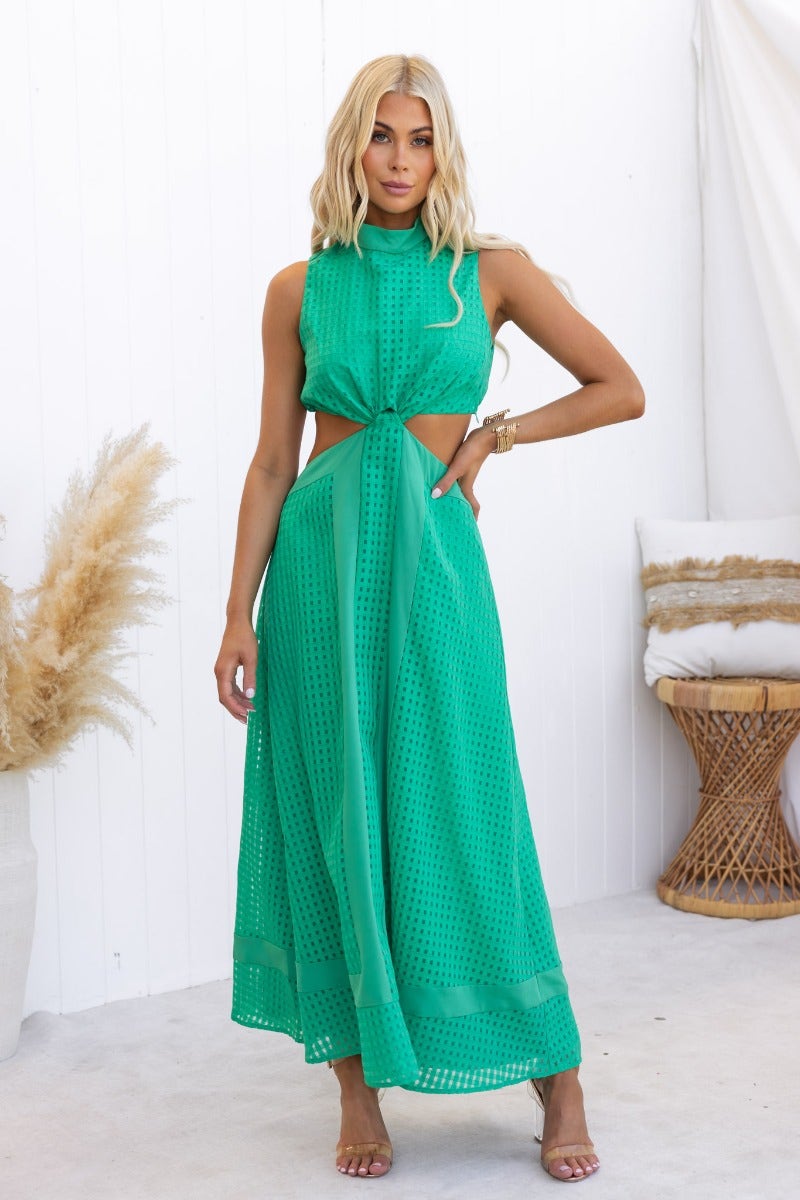 Model wearing a green Tamzin Maxi Dress with cut-out waist and textured fabric, perfect for summer events.