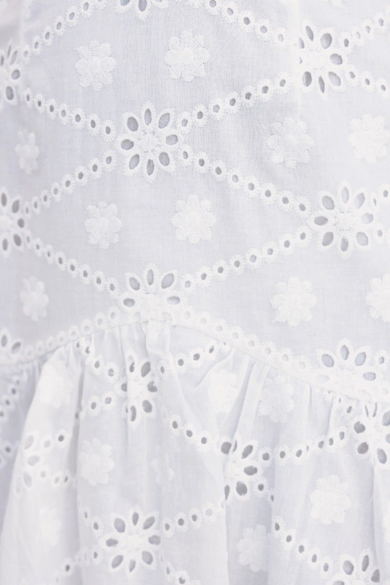 Close-up of Posey Dress in Anglaise fabric, showcasing floral embroidery and delicate cut-out details.