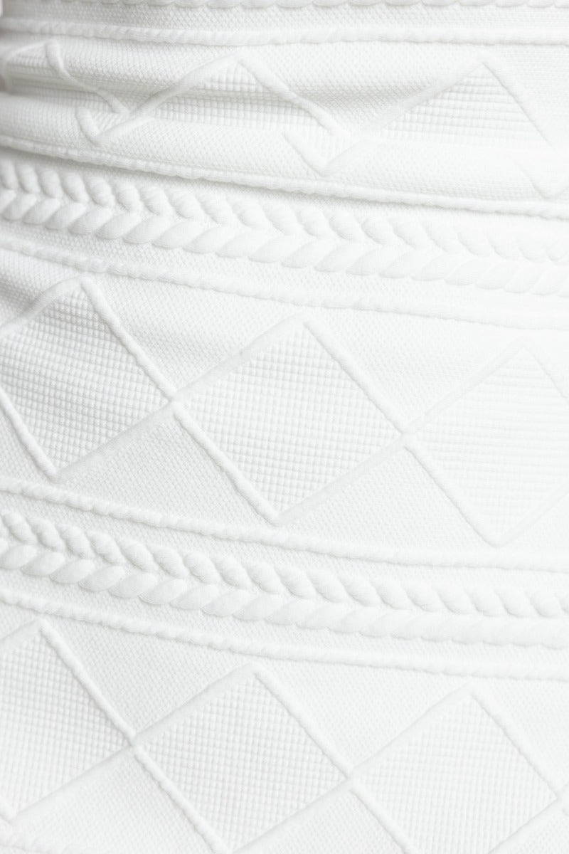 Textured white material close-up showing intricate patterns and designs for the Benzie Midi Dress.