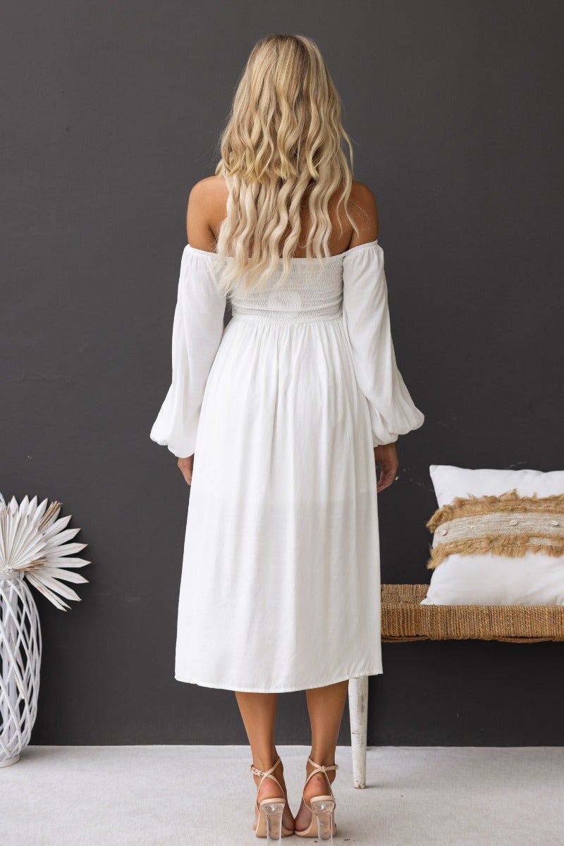 Back view of Lost Love Midi Dress in white, featuring off-shoulder sleeves and a flowing silhouette.