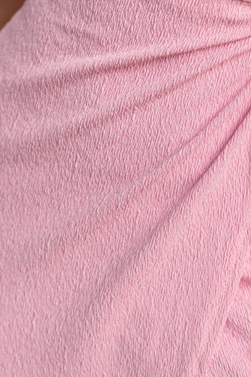 Close-up of textured pink fabric showcasing ruching details for Tayan Maxi Dress.