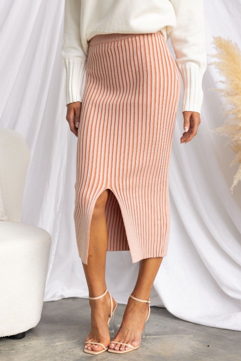 Viloa Midi Skirt in ribbed knit with elastic waistband and front split, styled with a knit sweater and heels.