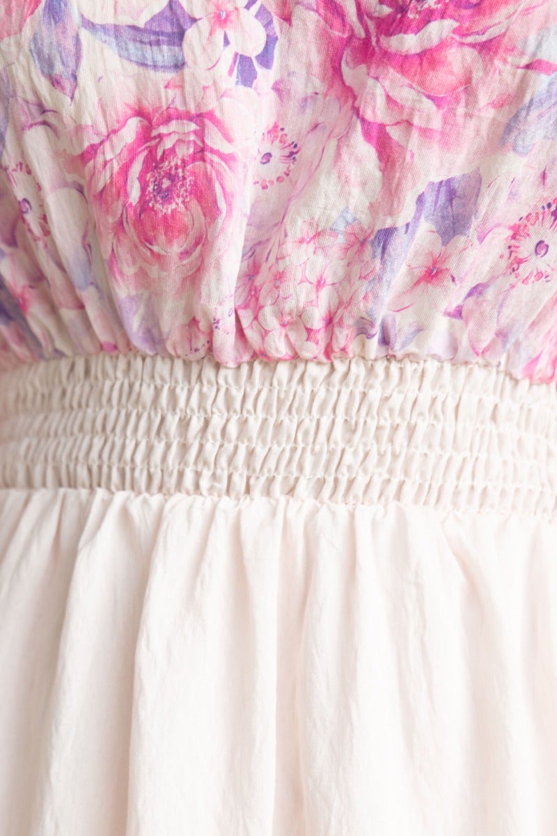Close-up of Aleyna Midi Dress featuring floral print bodice, elastic waistband, and pleated skirt for a stylish look.