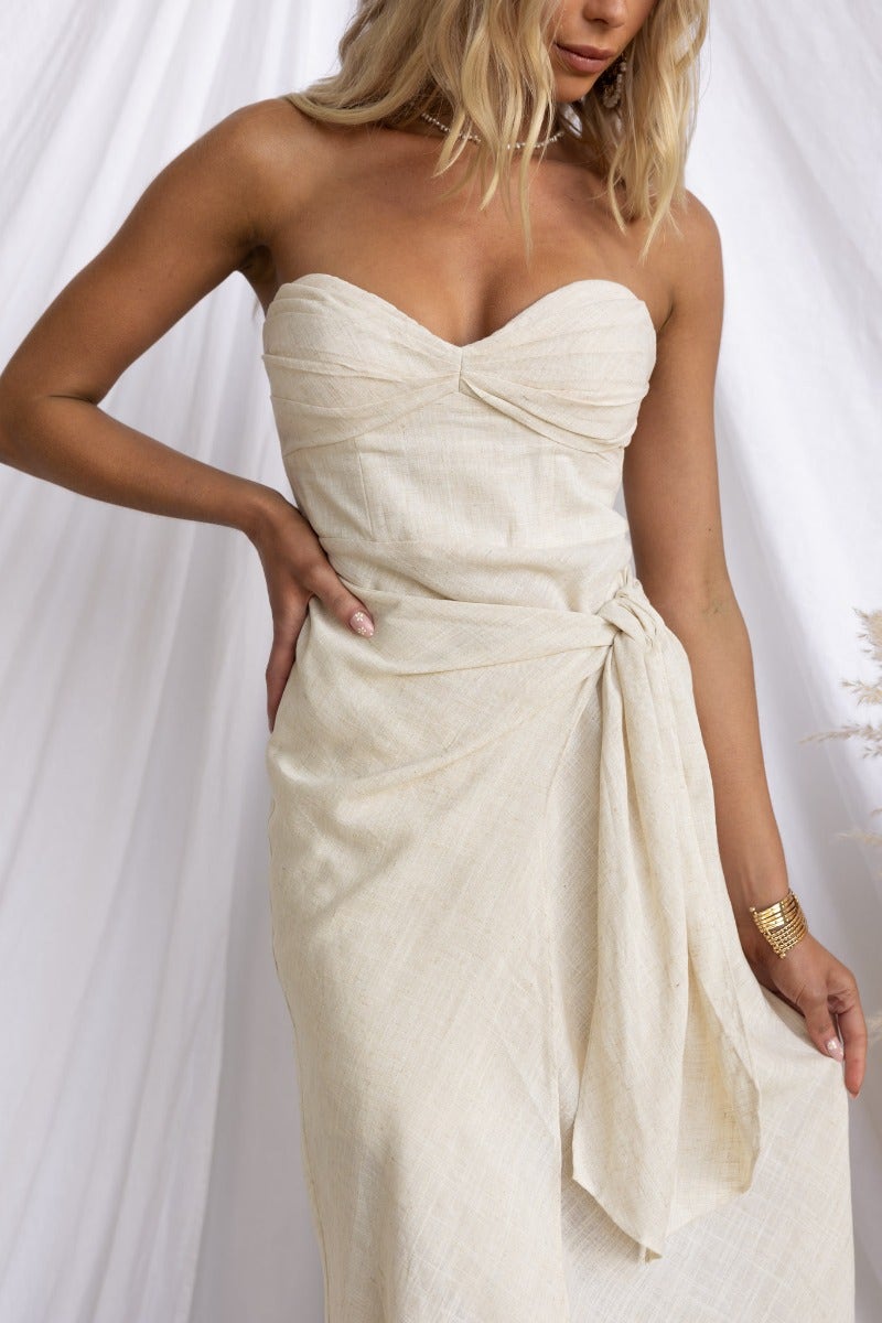 Gala Midi Dress in linen blend featuring strapless design, wrap skirt, and padded bust for an elegant look.