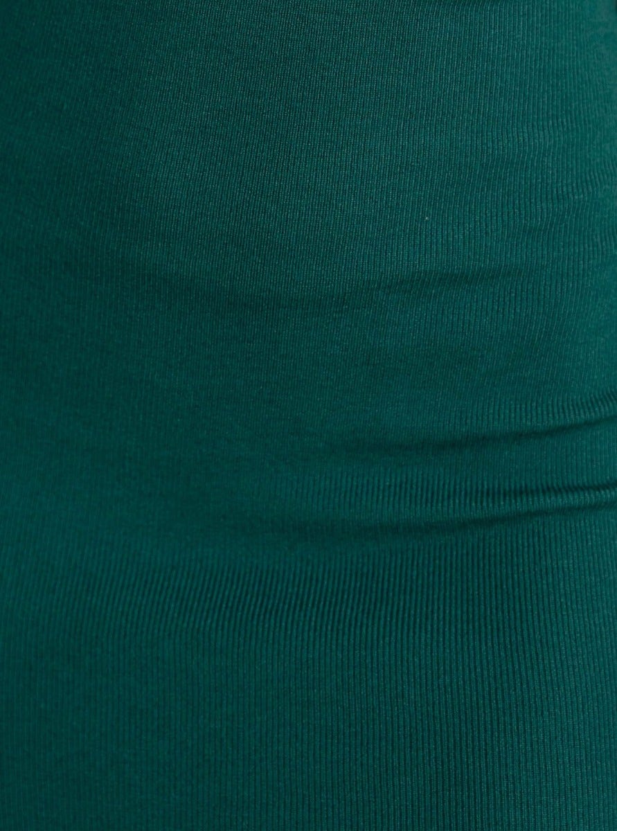 Close-up of the ribbed knit fabric of a green midi dress, showcasing its stretchy material and texture.