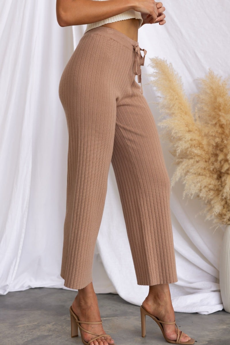Etta Pants: Women's ribbed knit wide-leg pants with elastic waistband and drawstring, in light brown color.