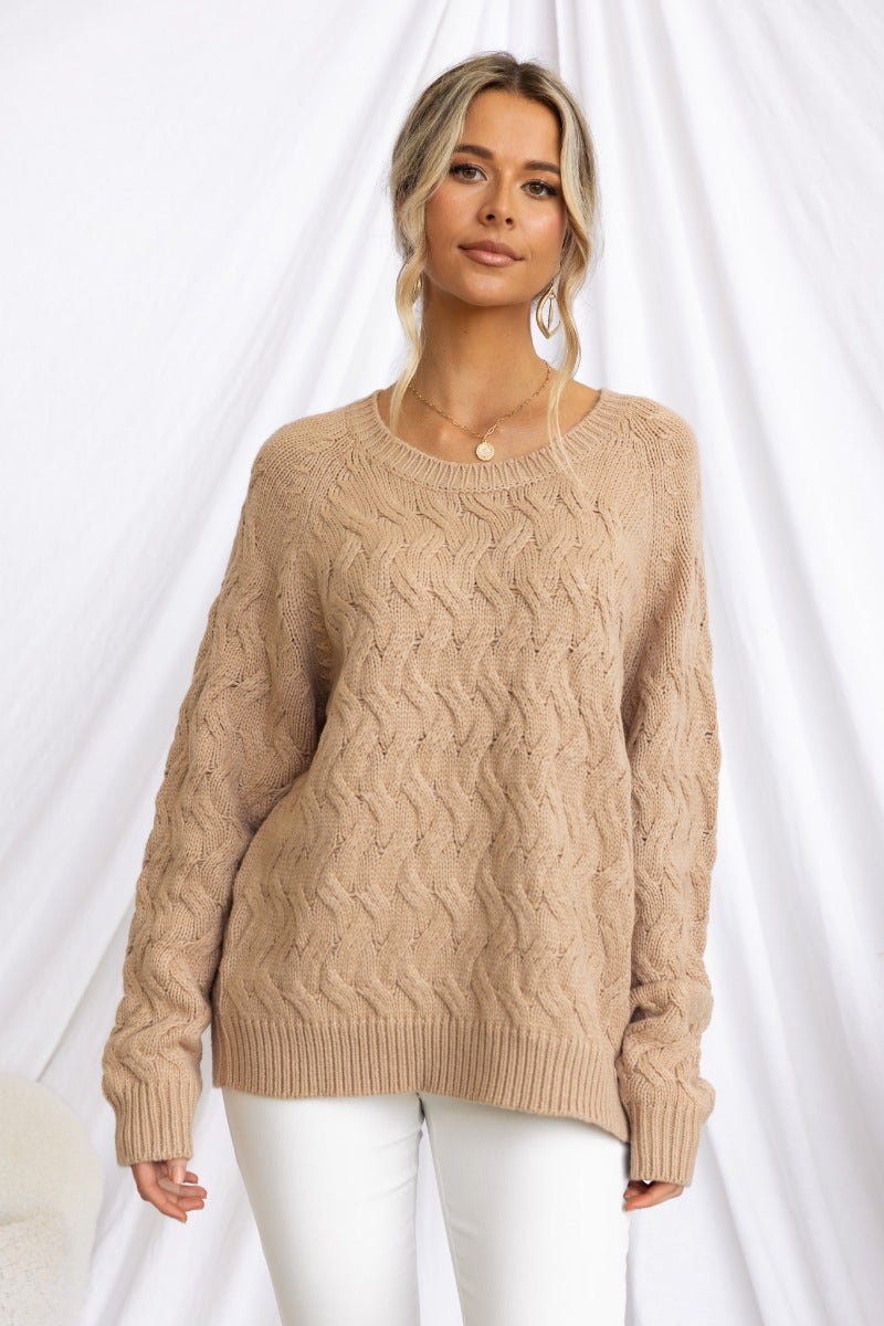 Renee jumper in cable knit style, featuring a round neckline and relaxed fit, worn by model against a neutral backdrop.