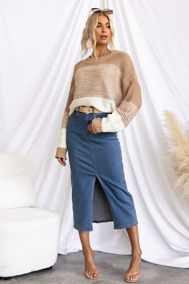 Model wearing a relaxed fit Burma Jumper with round neckline, paired with a denim skirt, styled for a chic look.