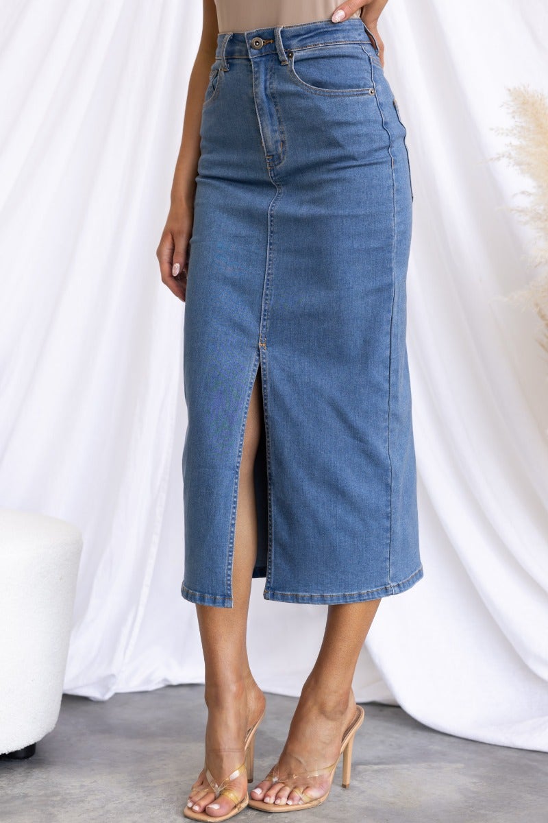 Evelyn Denim Midi Skirt in blue with front split, mid-high waist, featuring front and back pockets.