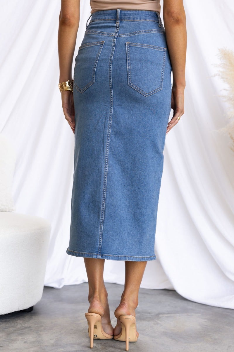 Back view of the Evelyn Denim Midi Skirt showing mid-high waist, pockets, and front split detail.