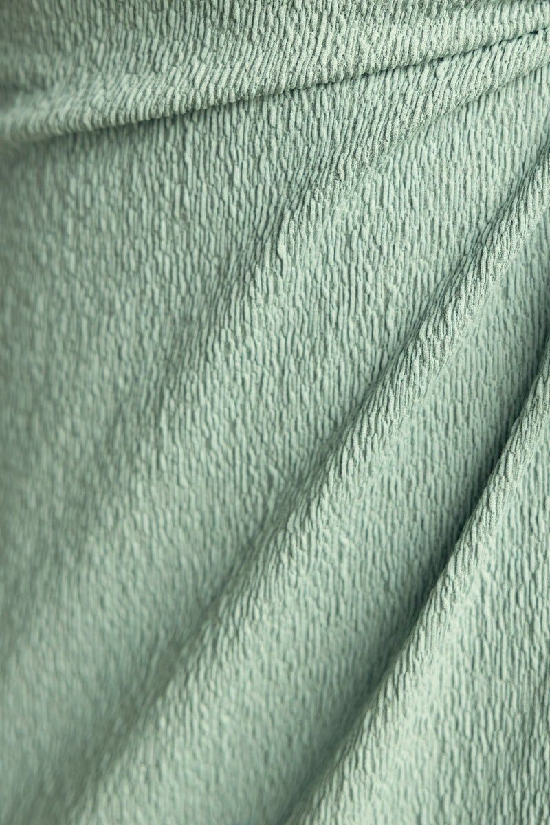 Textured mint green fabric showcasing soft stretch for Tayan Maxi Dress, highlighting its stylish design and comfort.