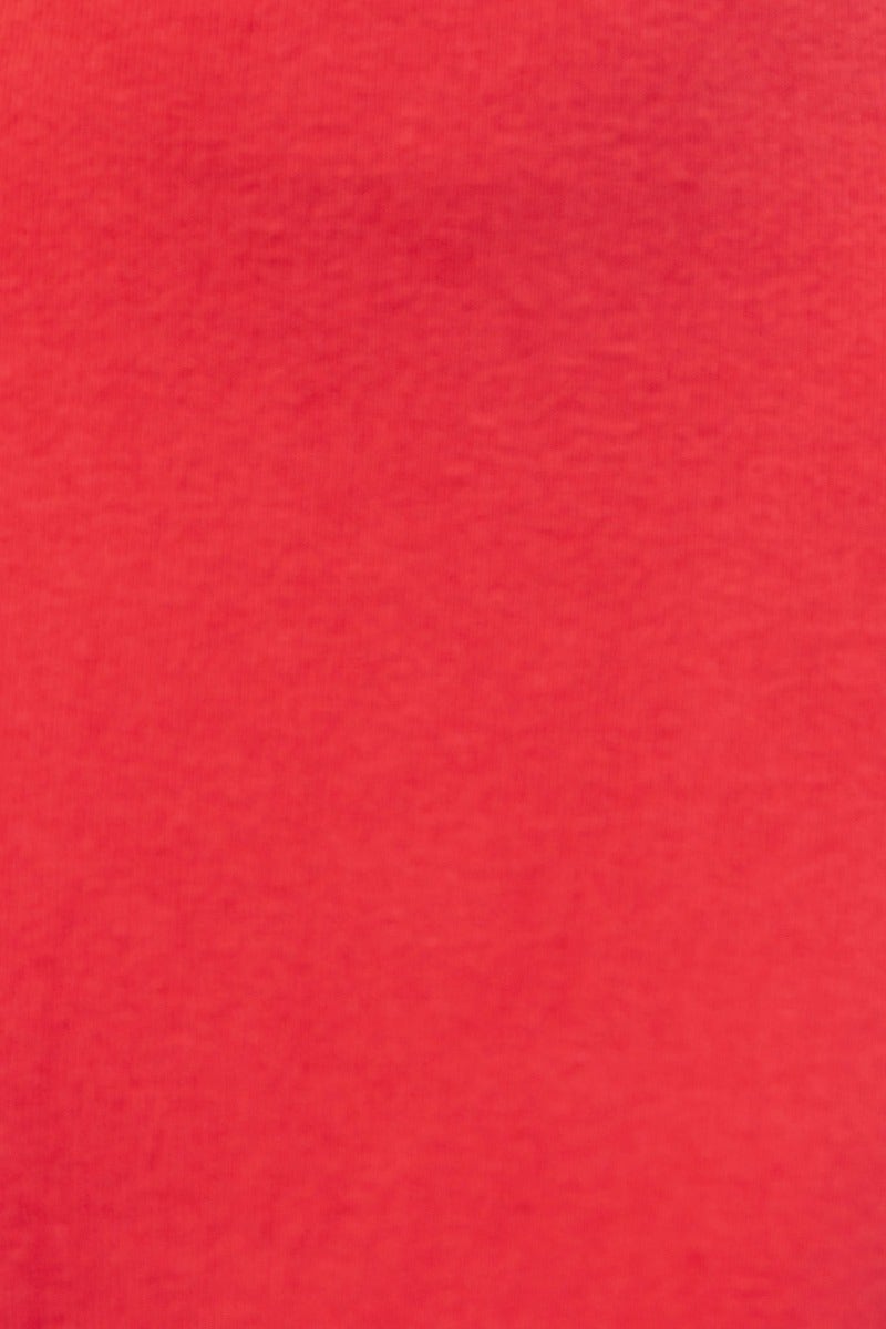 Close-up of a soft, ribbed red fabric, showcasing the texture ideal for stylish clothing like the Allie Midi Dress.