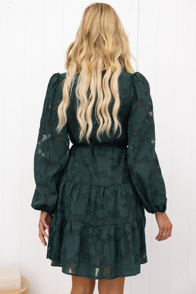 Back view of a green Halston Dress featuring embossed print, puffy sleeves, and a tiered skirt.