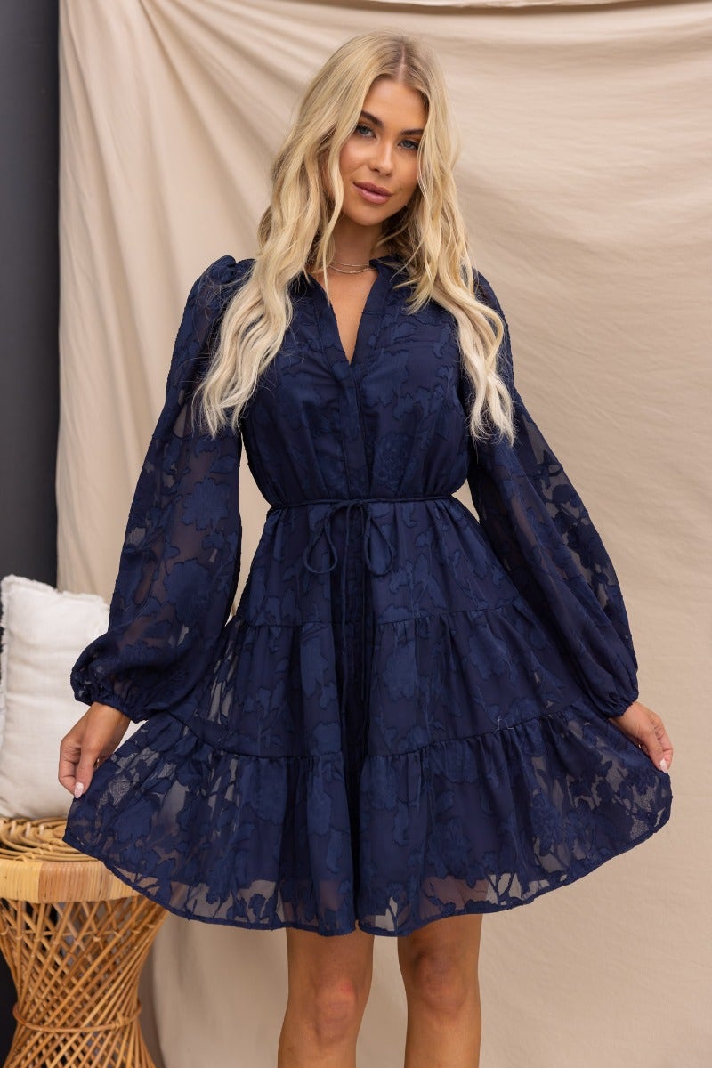 Navy embossed print Halston dress with button-up front and elastic sleeve cuffs, showcasing a tiered design.