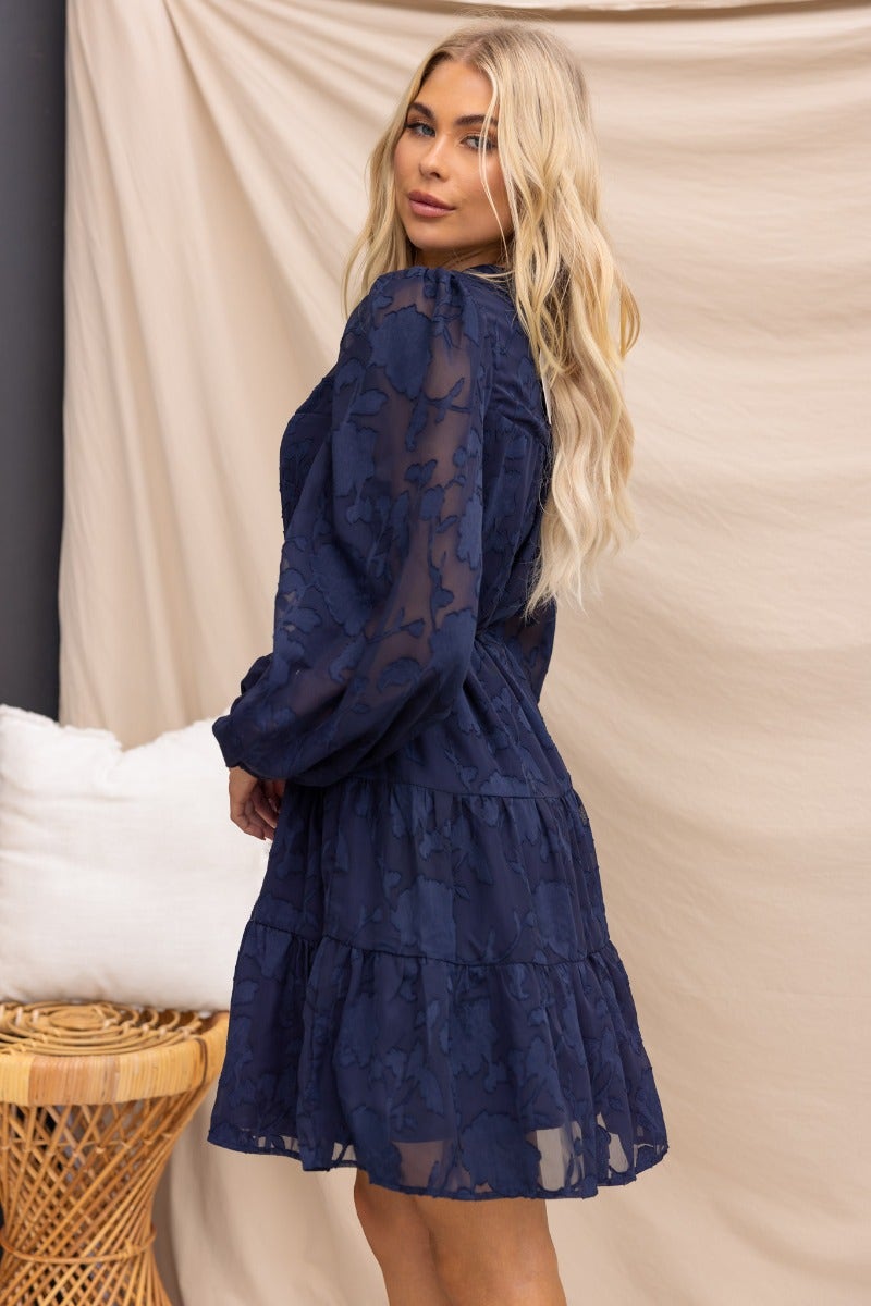 Navy Halston dress featuring an embossed print, button-up front, and elastic sleeve cuffs, styled gracefully.