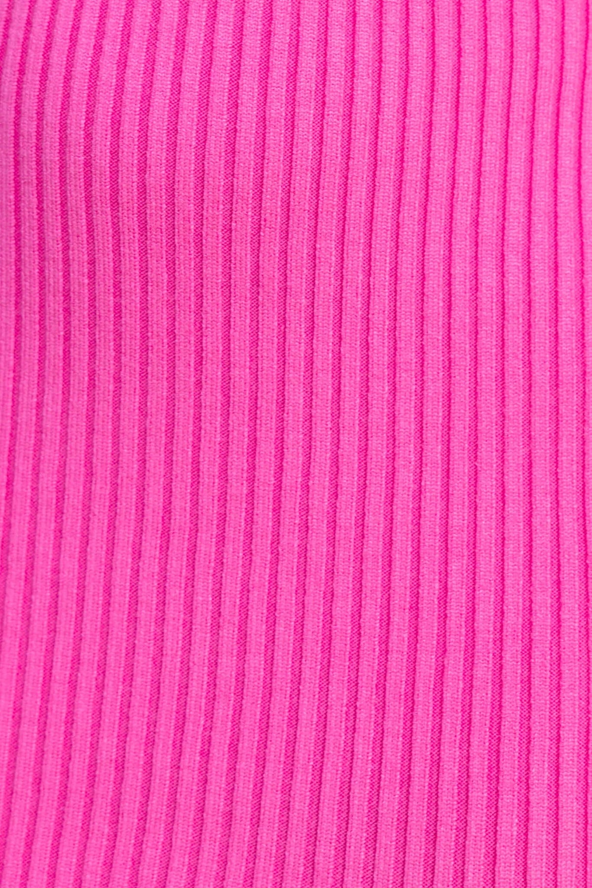 Close-up of bright pink ribbed knit fabric, showcasing its texture and stretch for a stylish dress.