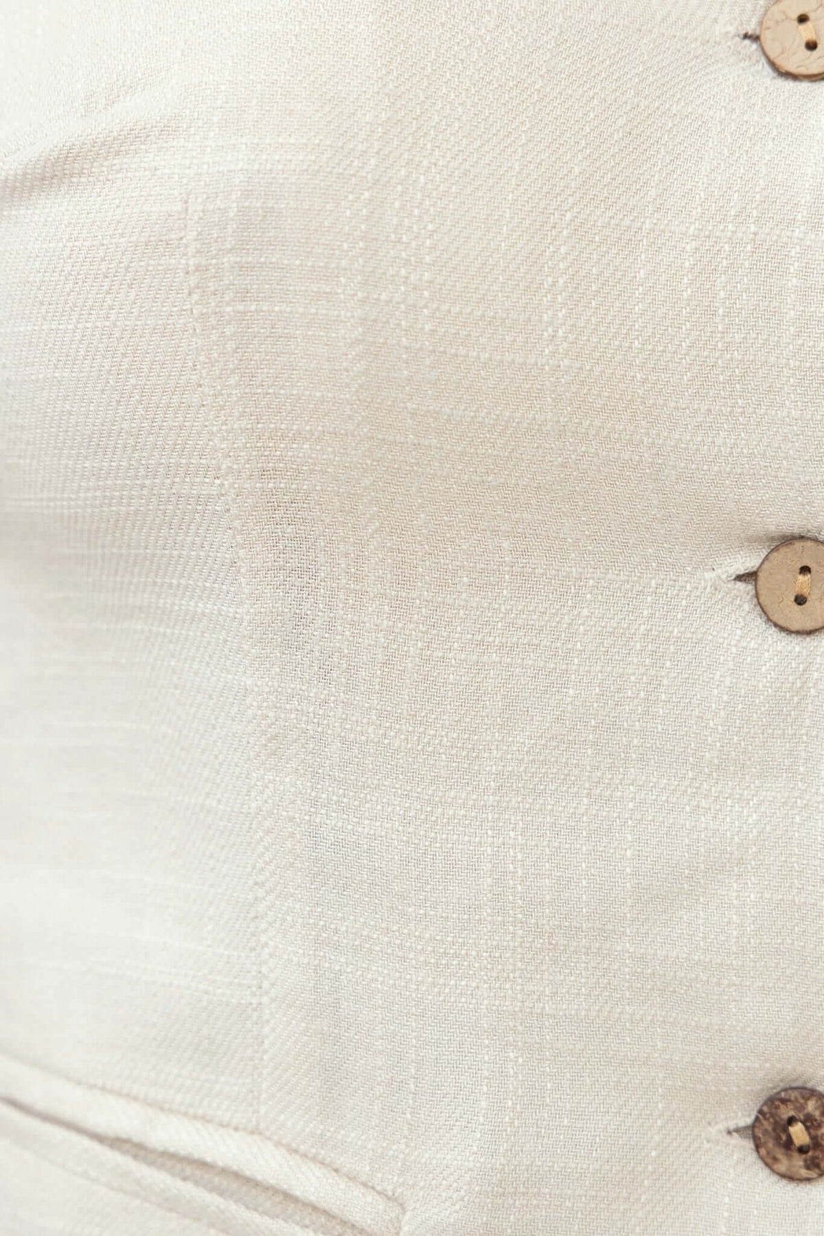 Close-up of Shelton Top featuring button-up front and faux pockets in light fabric.