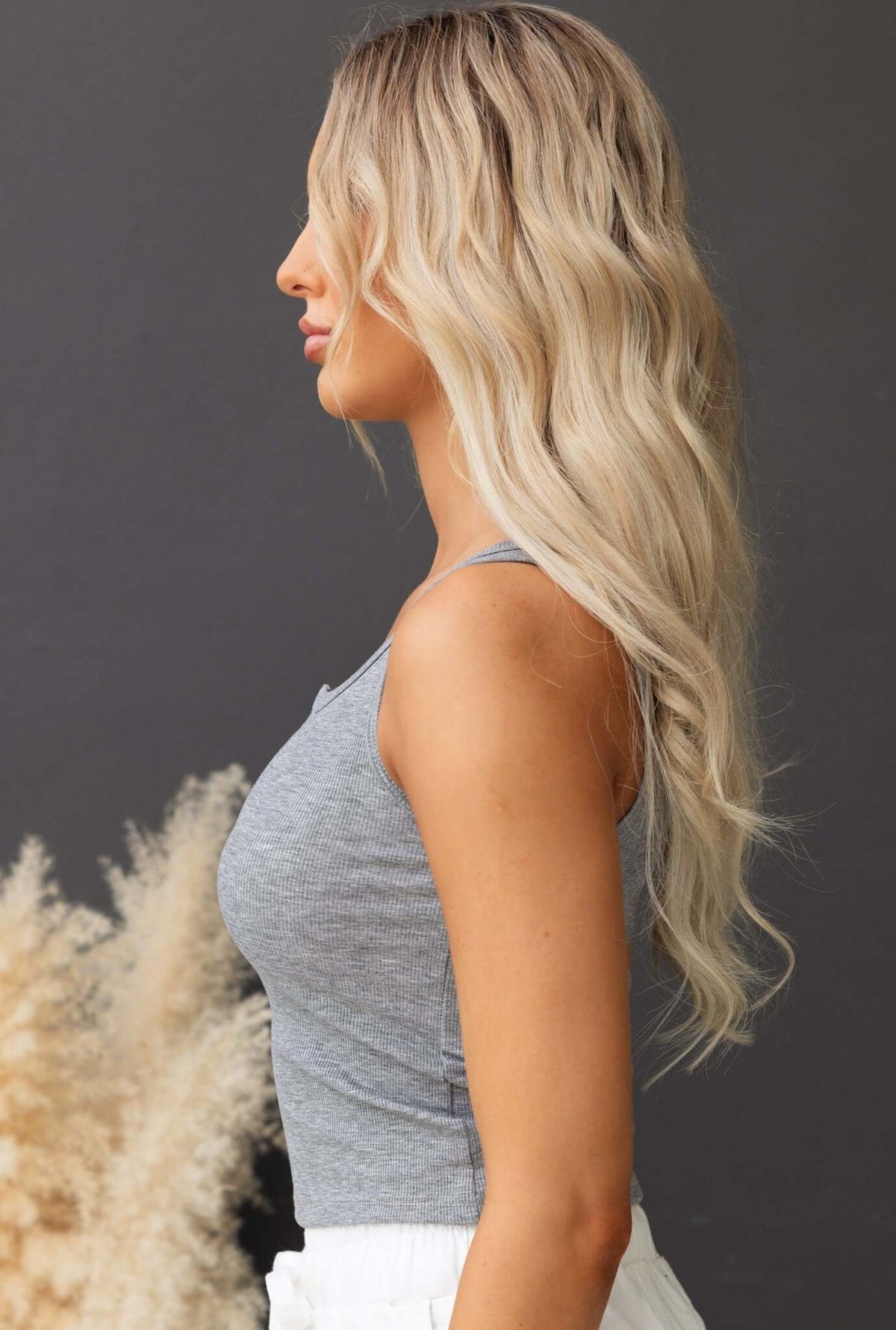 Jordi Top in gray ribbed material, featuring a fitted design and showcasing stylish side profile.