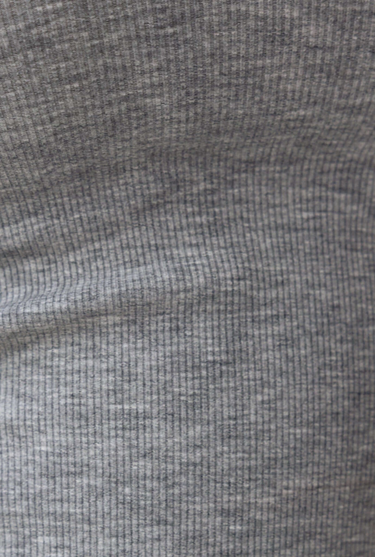 Close-up of ribbed gray fabric texture for the Jordi Top with stretchy polyester and spandex blend.