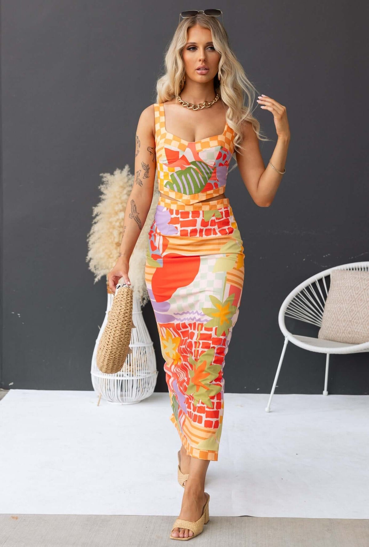 Model wearing Paltrow Set featuring a floral print top and non-stretch maxi skirt with adjustable straps.