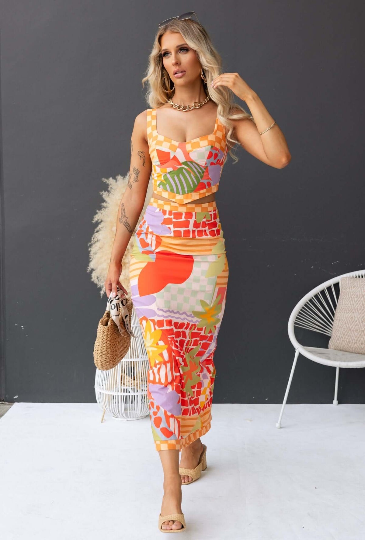 Model wearing the Paltrow Set, featuring a colorful floral print and non-stretch maxi skirt with adjustable straps.