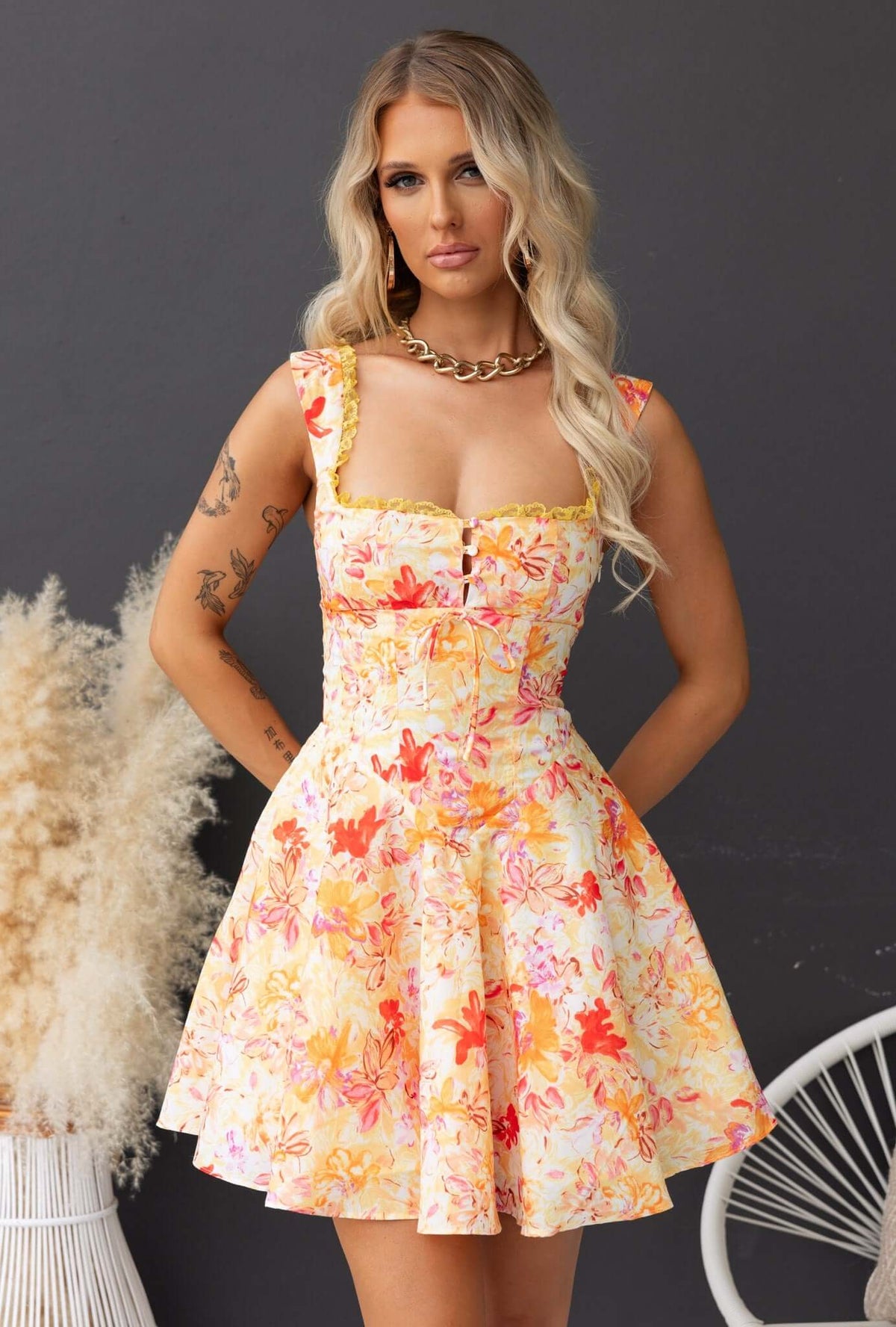 Elixir Dress with floral design, adjustable straps, button detail, and tulle underlay, perfect for summer styling.