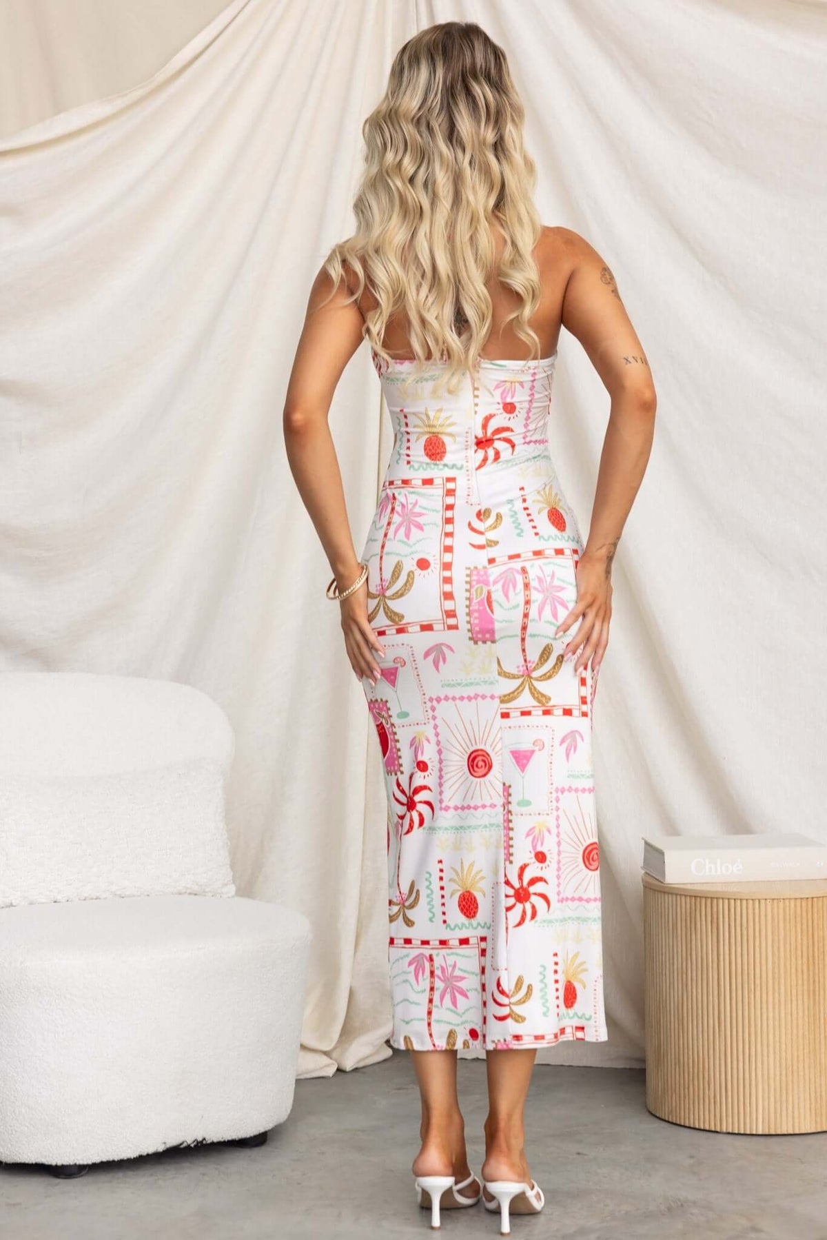 Back view of Carianne Midi Dress featuring vibrant patterns and a strapless design, perfect for summer events.