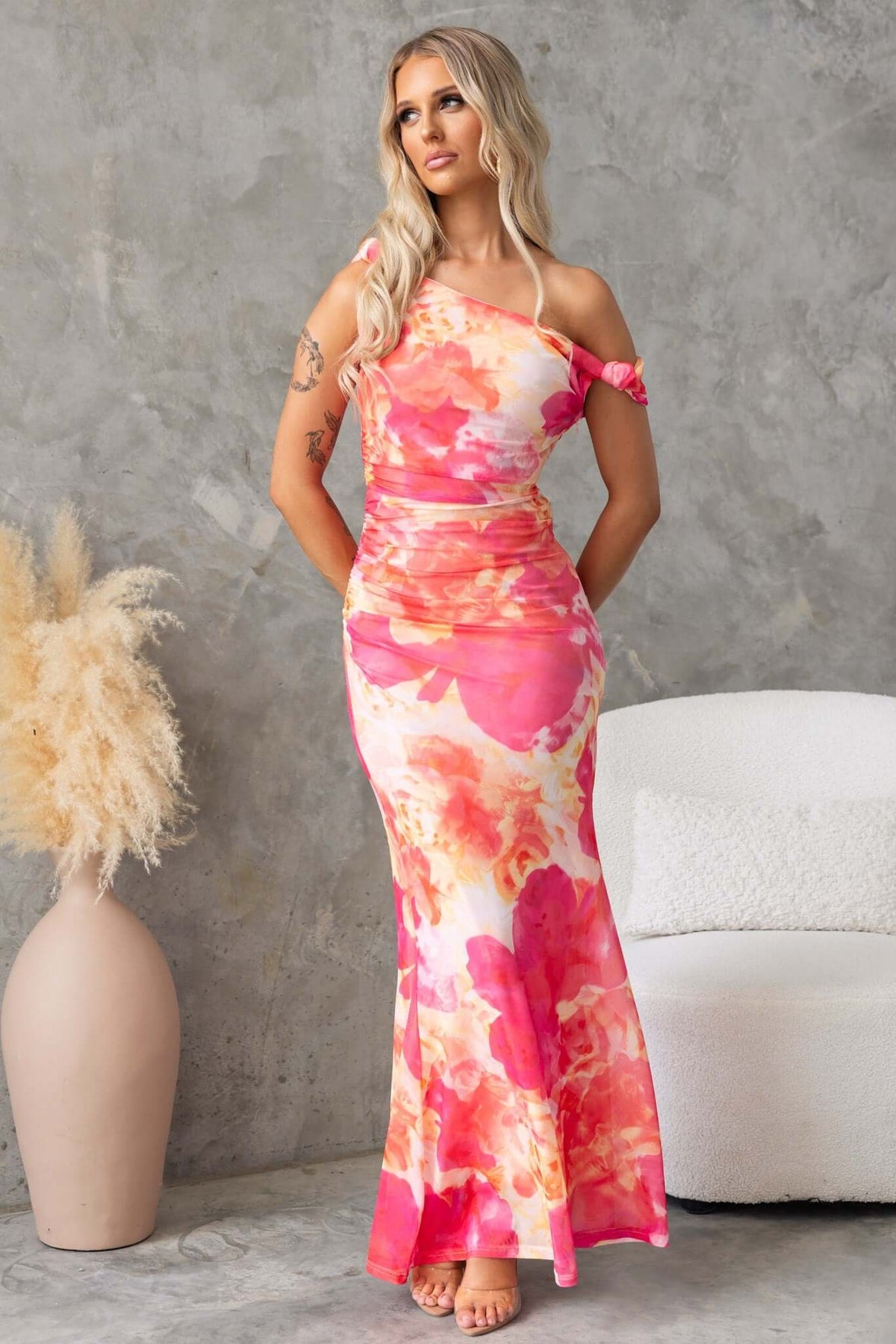 Fellaire Maxi Dress featuring an asymmetric neckline, floral print, and mesh material, styled with a side zip and knots at strap.