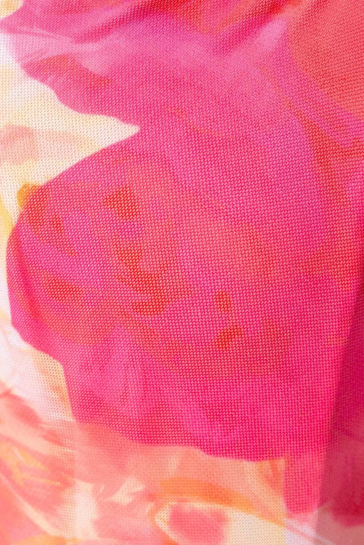 Close-up of Fellaire Maxi Dress featuring vibrant pink and orange mesh floral pattern, showcasing its lined, stretchy material.