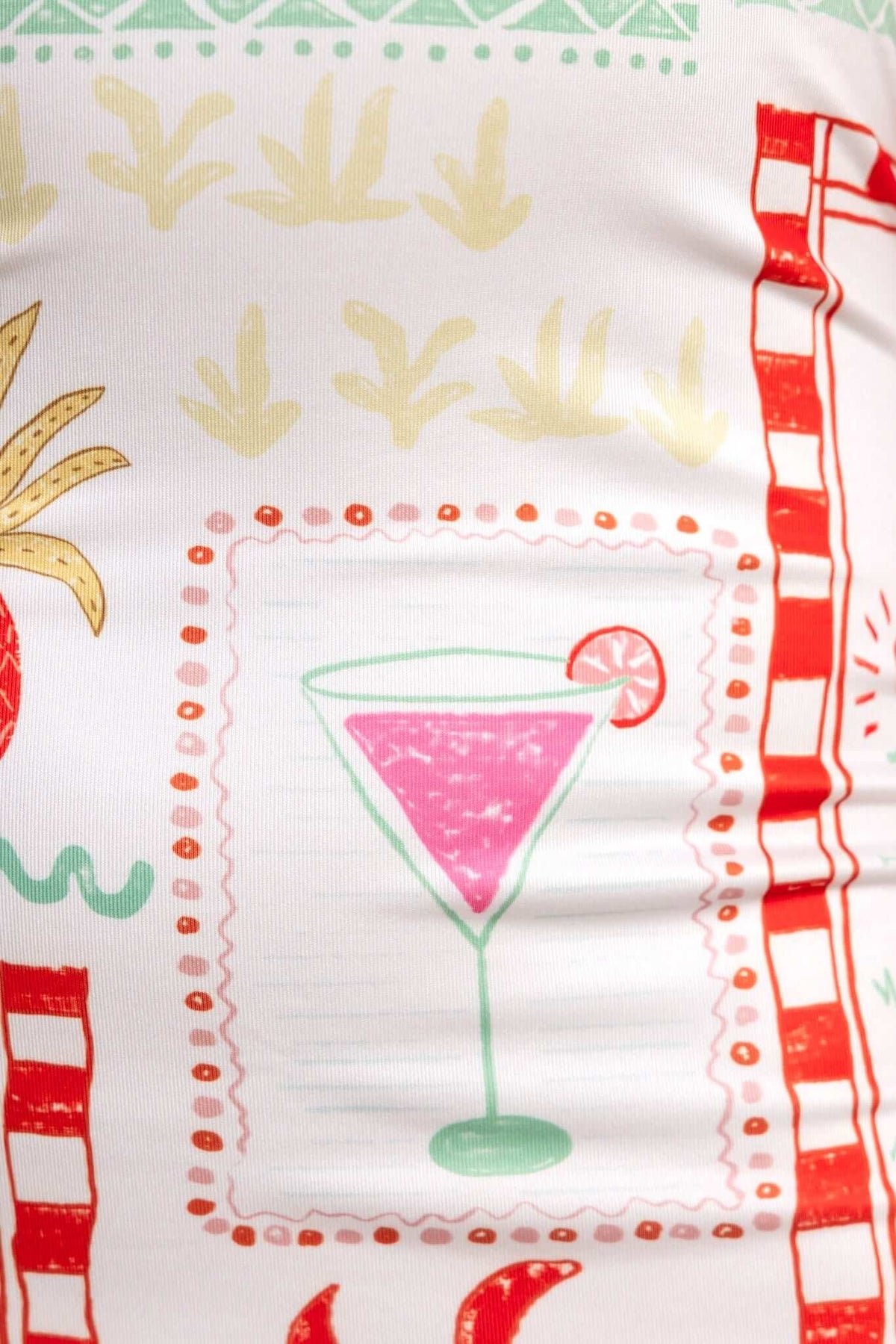 Colorful print featuring a pink cocktail glass surrounded by tropical designs and vibrant patterns.