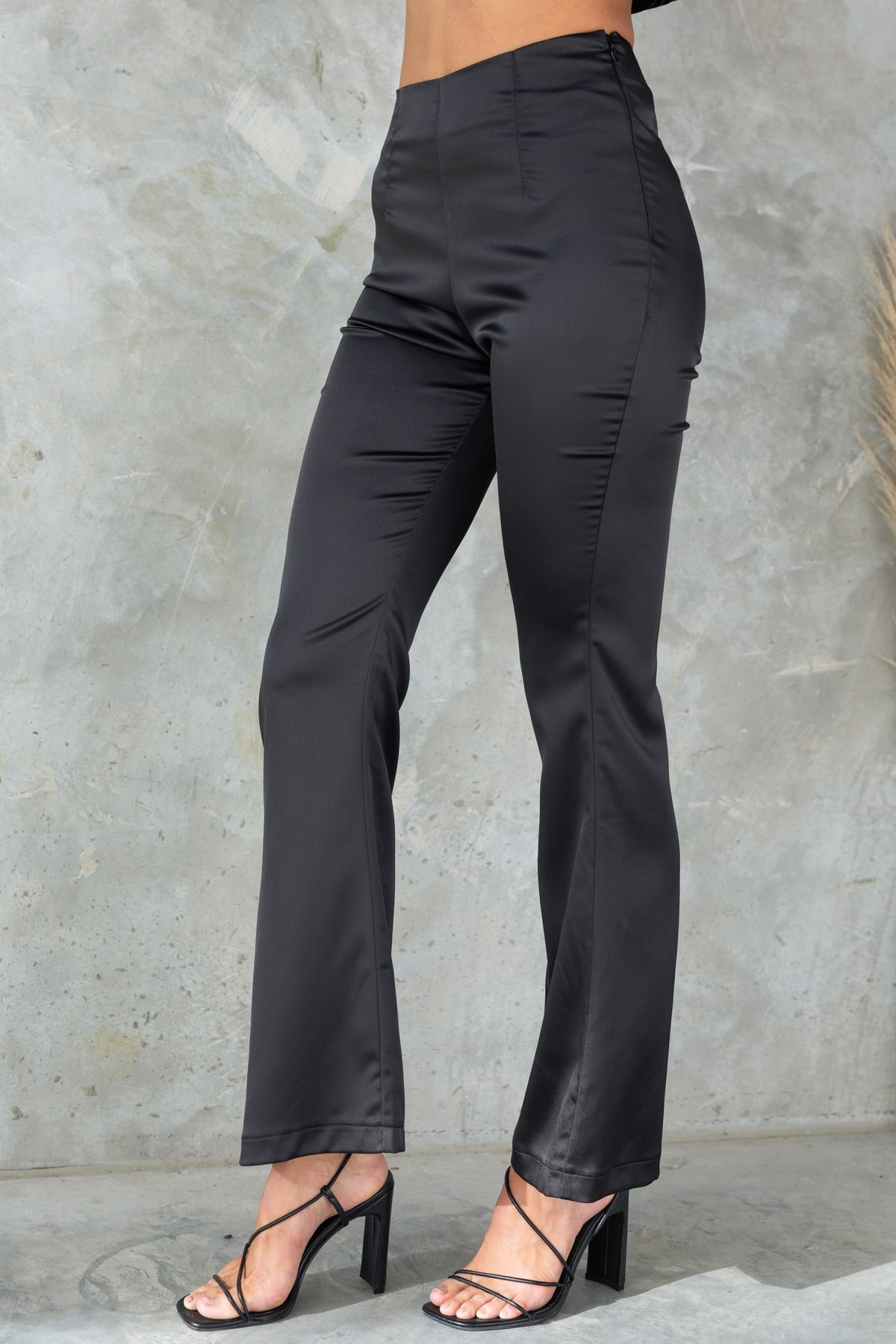 Amore Pants: Black mid-high waist satin flare leg pants with invisible zip and firm stretch fit.