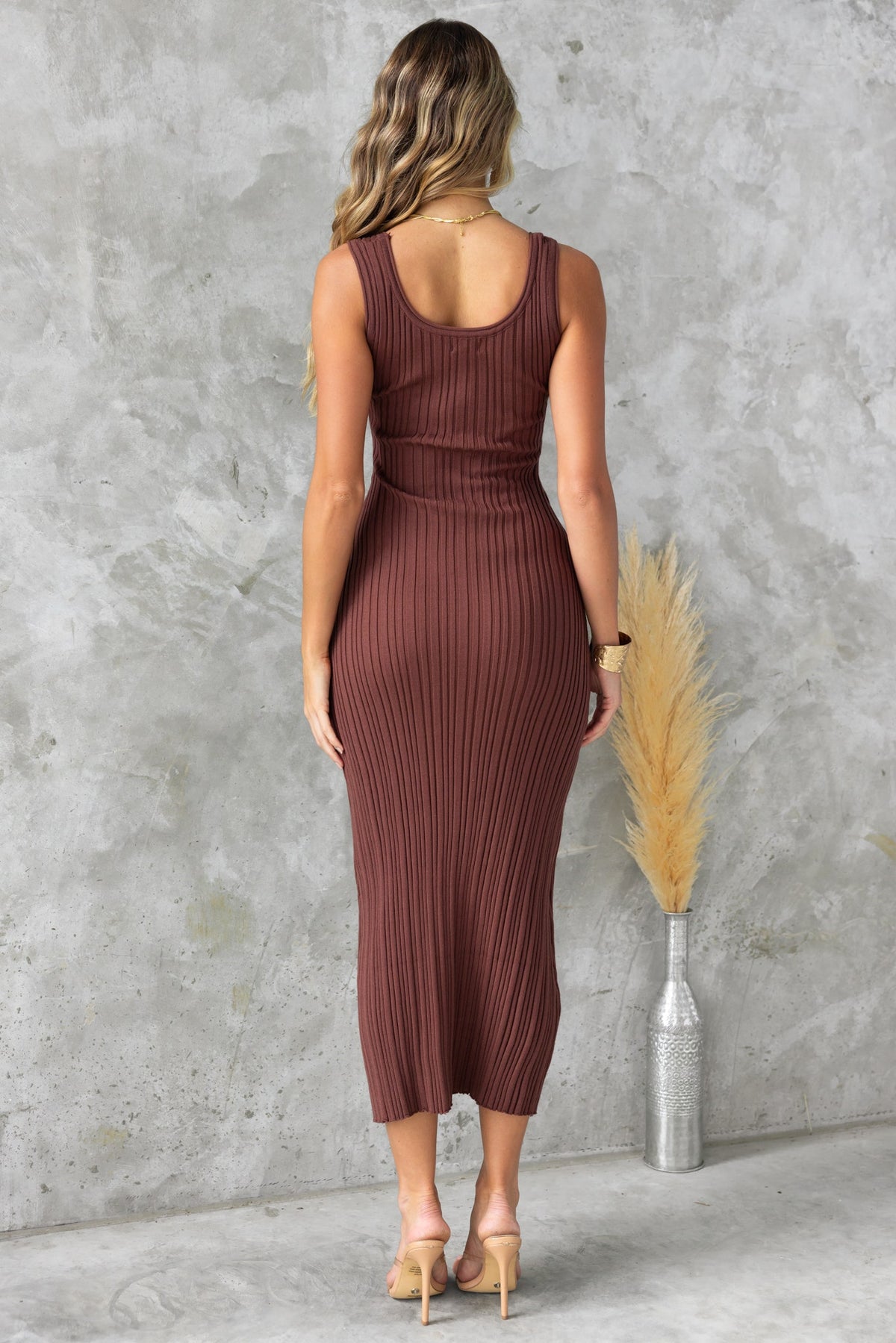 Back view of a brown ribbed knit Dera Midi Dress with a round neckline and a flattering fit.