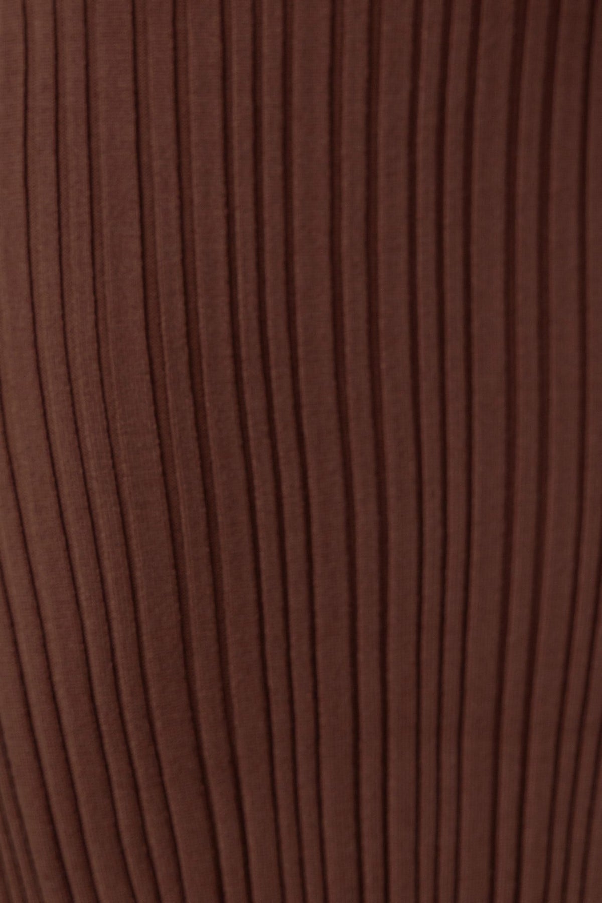Close-up of ribbed knit texture in a rich brown color, showcasing the stretch material of the Dera Midi Dress.