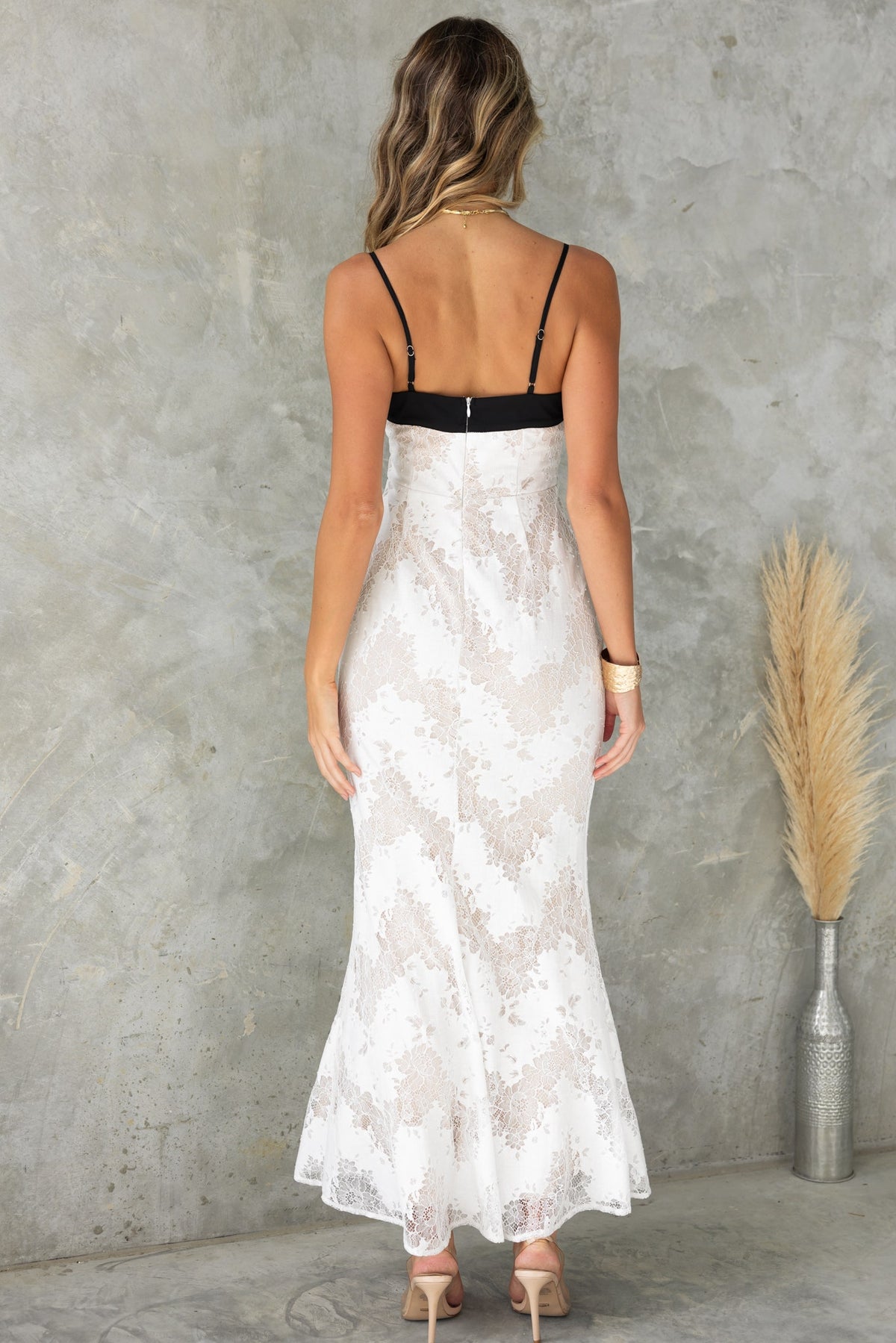 Back view of Seren Maxi Dress featuring lace material, adjustable straps, and a square neckline.