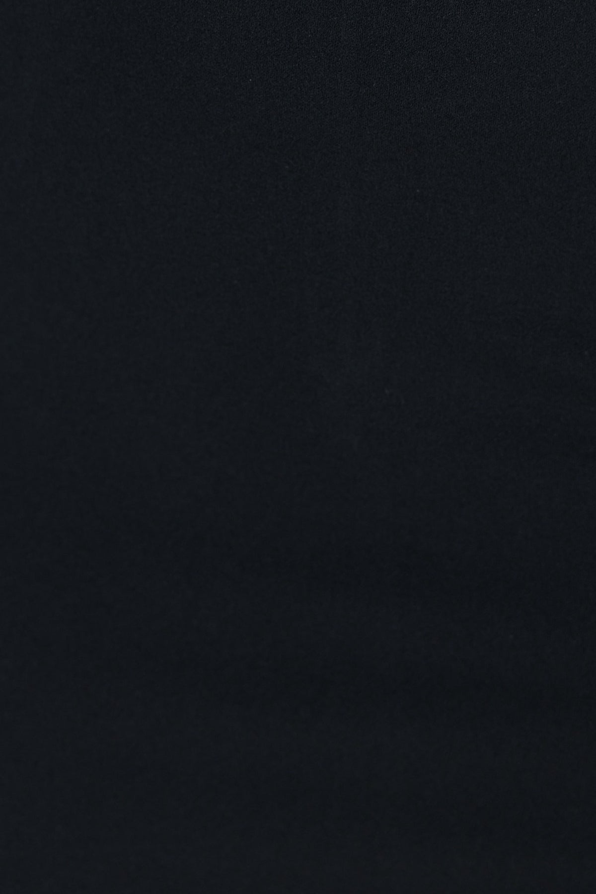 Close-up of black crepe fabric, showcasing smooth texture for the Lerato Midi Dress.